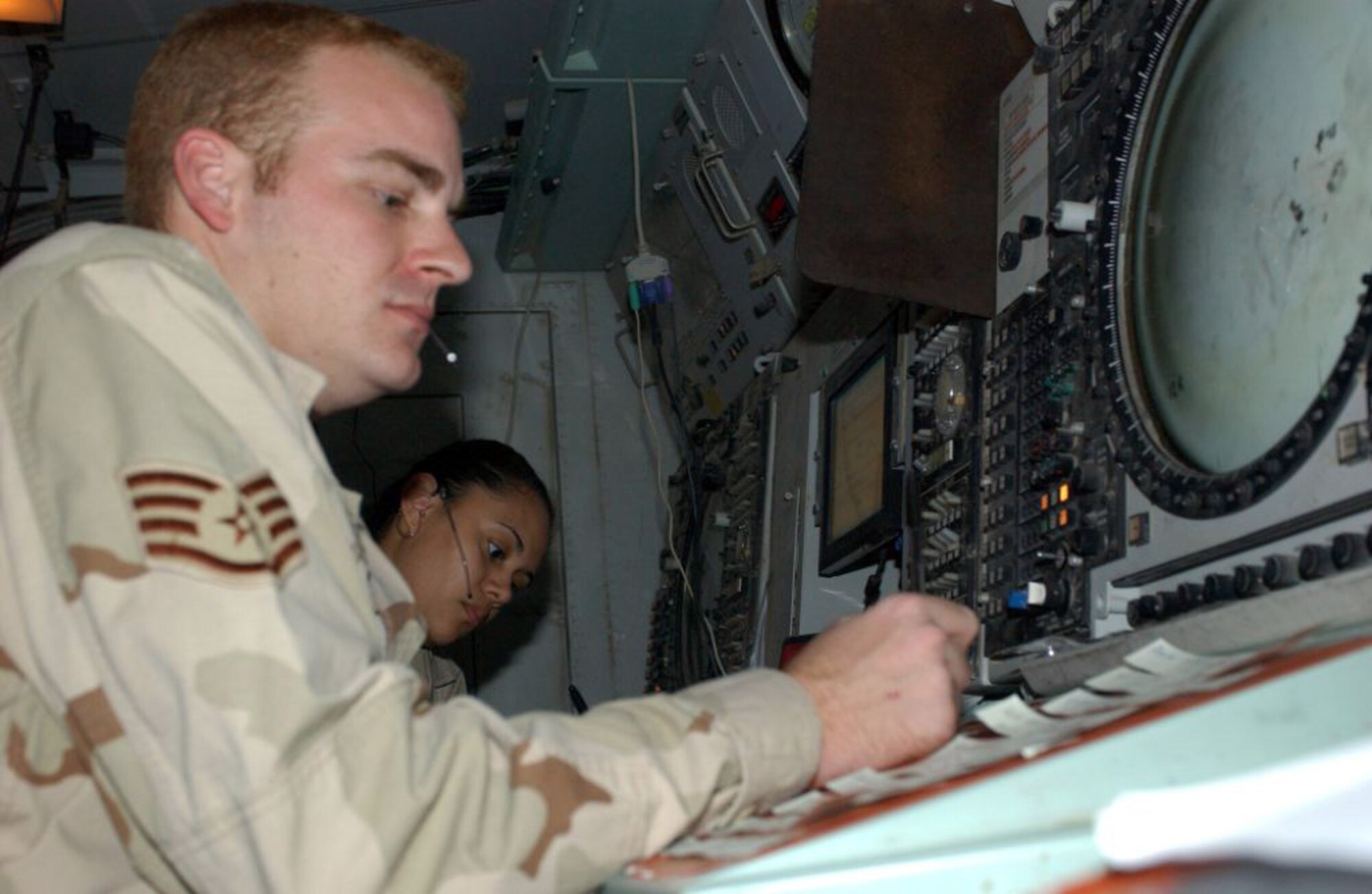 Staff Sgt. Scott Williams and Senior Airman Andrena Guerra work flight requests at the Ali Base, Iraq, area control center. (U.S. Air Force photo/Master Sgt. Jon Hanson) 
