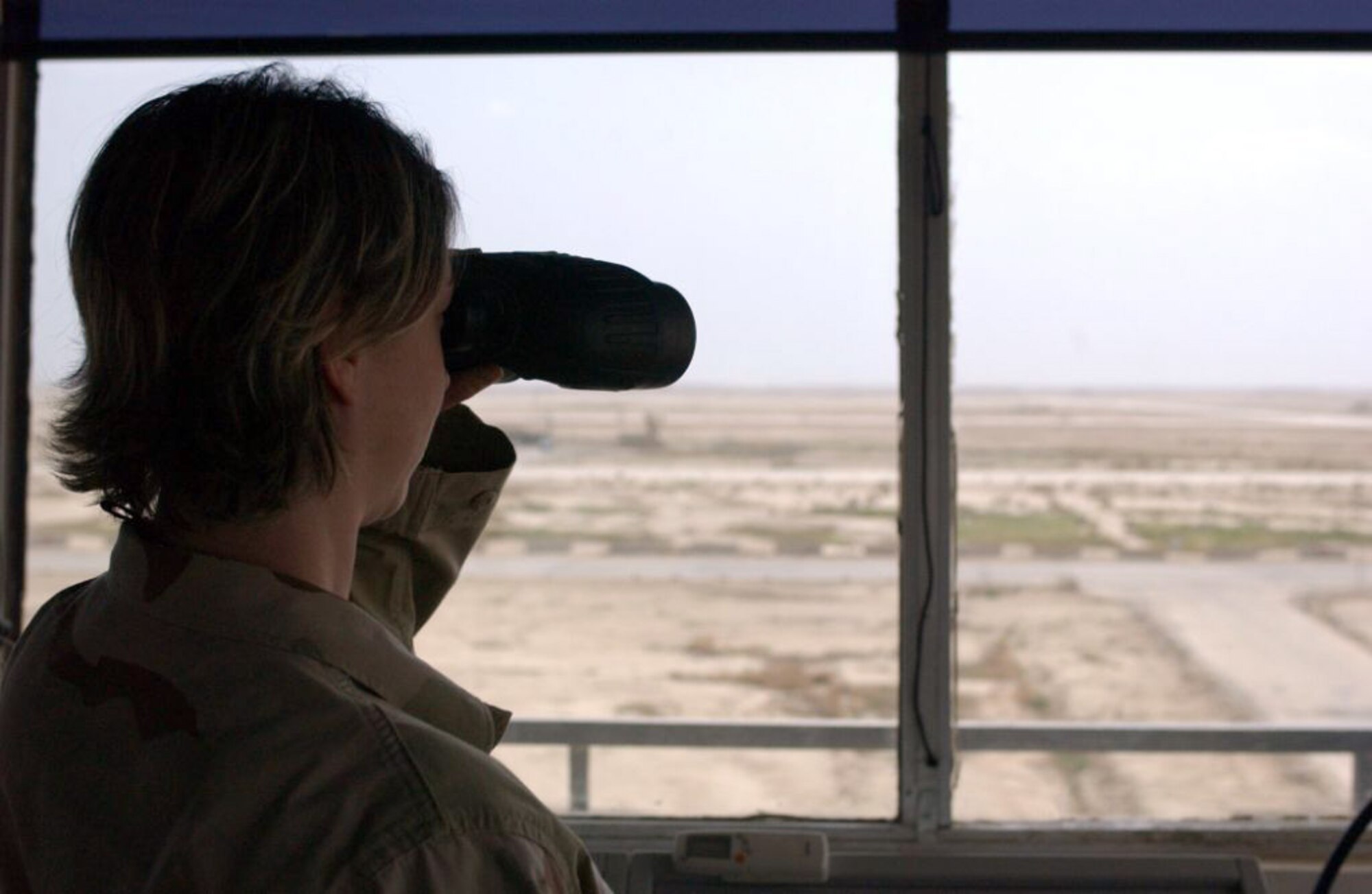 Staff Sgt. Nichole Heise, an air traffic controller at the control tower at Ali Base, Iraq, tracks a departing aircraft. Sergeant Heise is deployed to the 407th Expeditionary Operations Support Squadron from Beale Air Force Base, Calif. (U.S. Air Force photo/Master Sgt. Jon Hanson) 
