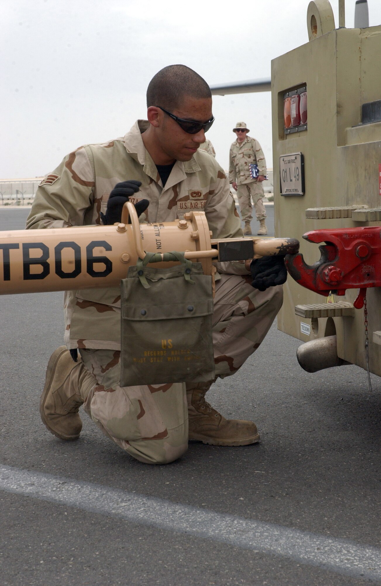 Senior Airman Saul Mendoza links a C-130J Hercules to an aircraft tow tractor at a deployed location in Southwest Asia on Wednesday, April 5, 2006.  Airman Mendoza is with the 747th Aircraft Maintenance Unit. (U.S. Air Force photo/Senior Airman Anthony Nelson)