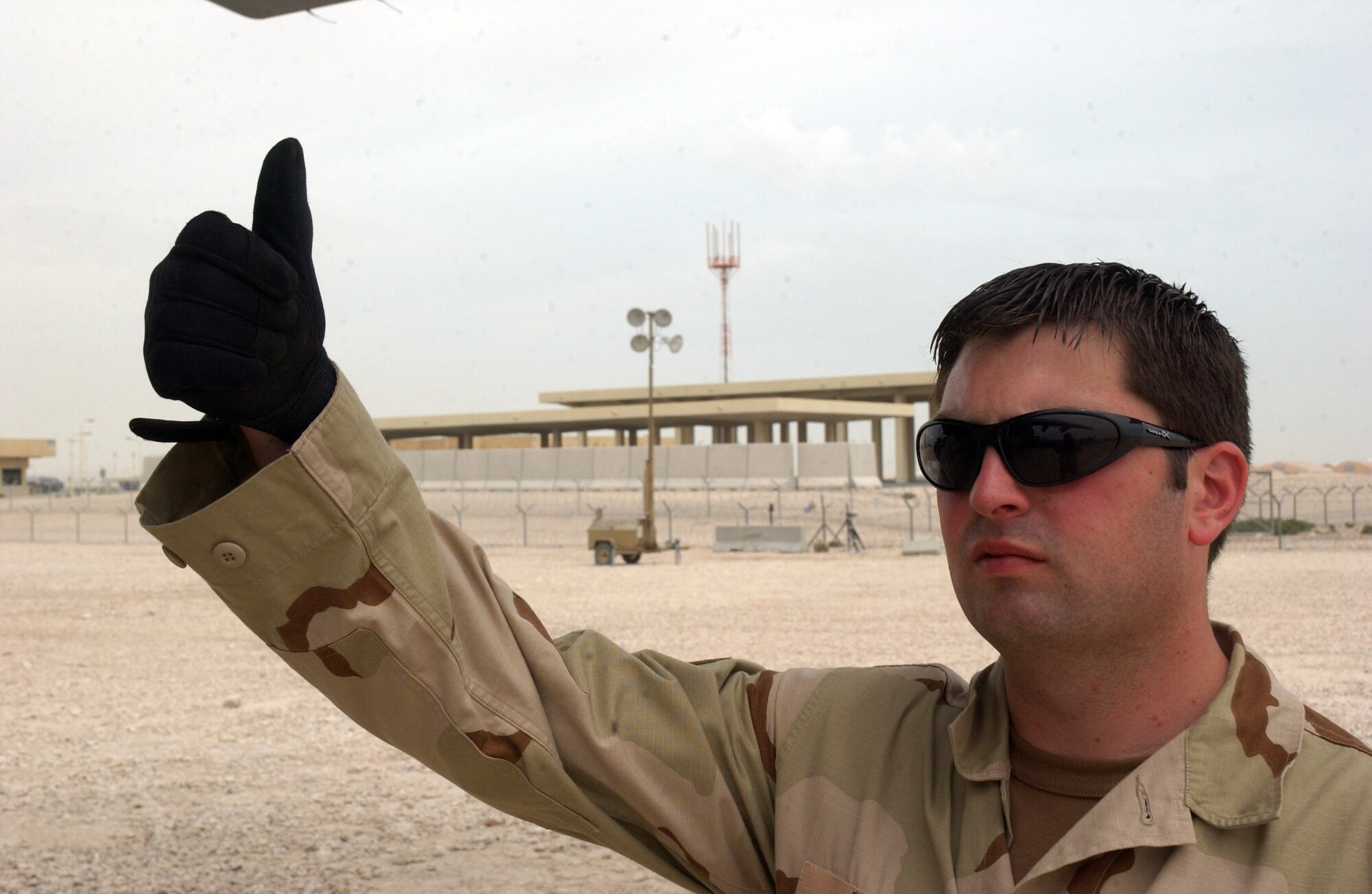 Staff Sgt. Christopher Zink gives a thumbs up to a C-130J Hercules crew at a deployed location in Southwest Asia on Wednesday, April 5, 2006. Sergeant Zink is with the 747th Aircraft Maintenance Unit. (U.S. Air Force photo/Senior Airman Anthony Nelson) 