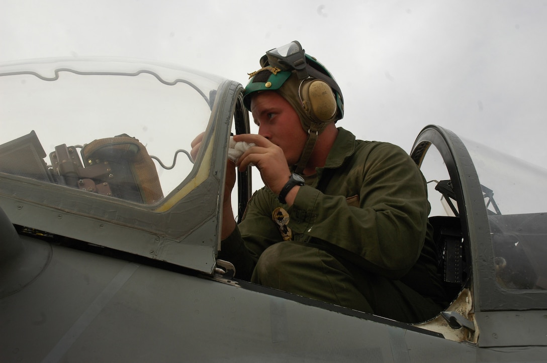 Lance Cpl. Damian G. Duchene, wipes down the canopy of an AV-8B Harrier, ensuring the pilot receives maximum visibility while in flight on the flight line in Al Asad, Iraq, April 11. Duchene, a fixed-wing aircraft safety equipment mechanic and native of Bristol, Conn., works in Marine Attack Squadron 513, Marine Aircraft Group 16 (Reinforced), 3rd Marine Attack Wing's, ejection seat shop.