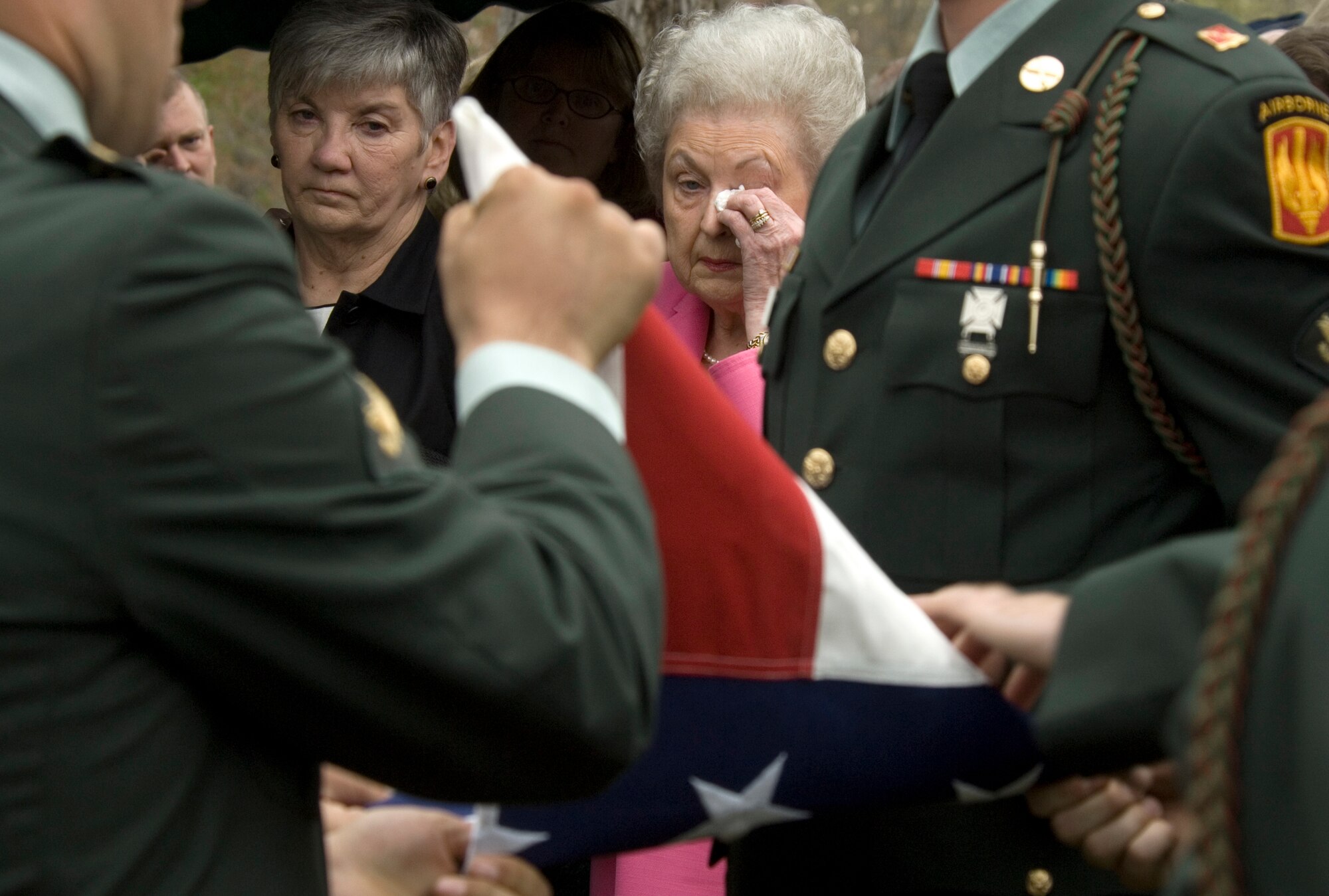 Joan Kitchen, niece, (left) and Lola Upchurch, sister-in-law, watch members of the 82nd Airborne at Fort Bragg, N.C., fold the flag Saturday, April 8, 2006, during a memorial service for 2nd Lt. Robert Hoyle Upchurch.  The lieutenant was a member of the famed Flying Tigers during World War II and was listed as missing in action until his remains were identified last May by the Joint POW/MIA Accounting Command.  (U.S. Air Force photo/Master Sgt. Jack Braden)