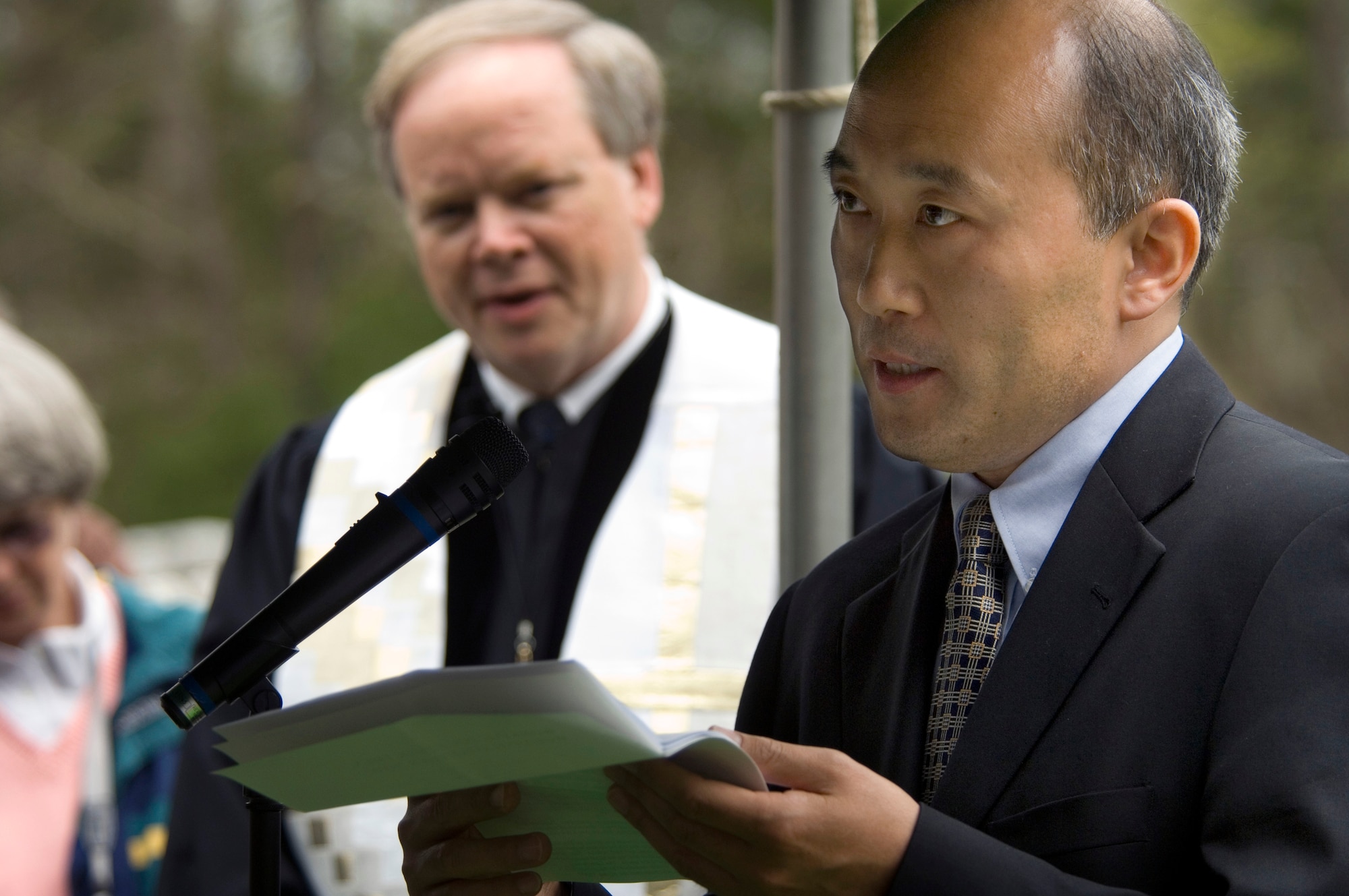 Jia Xiudong, representing the Chinese Embassy in Washington, D.C., reads a letter from Huang Renzhun during memorial services for 2nd Lt. Robert Hoyle Upchurch on Saturday, April 8, 2006.  Lieutenant Upchurch was a member of the famed Flying Tigers during World War II and was listed as missing in action until his remains were identified last May by the Joint POW/MIA Accounting Command.  In his letter, Mr. Huang tells how, as a young boy, he remembered the body of an American pilot being recovered and given a ceremonial burial in the village of Guidong, Hunan Province.  The villagers maintained the burial site more than 60 years until Lieutenant Upchurch's remains were returned to the U.S.  (U.S. Air Force photo/Master Sgt. Jack Braden)