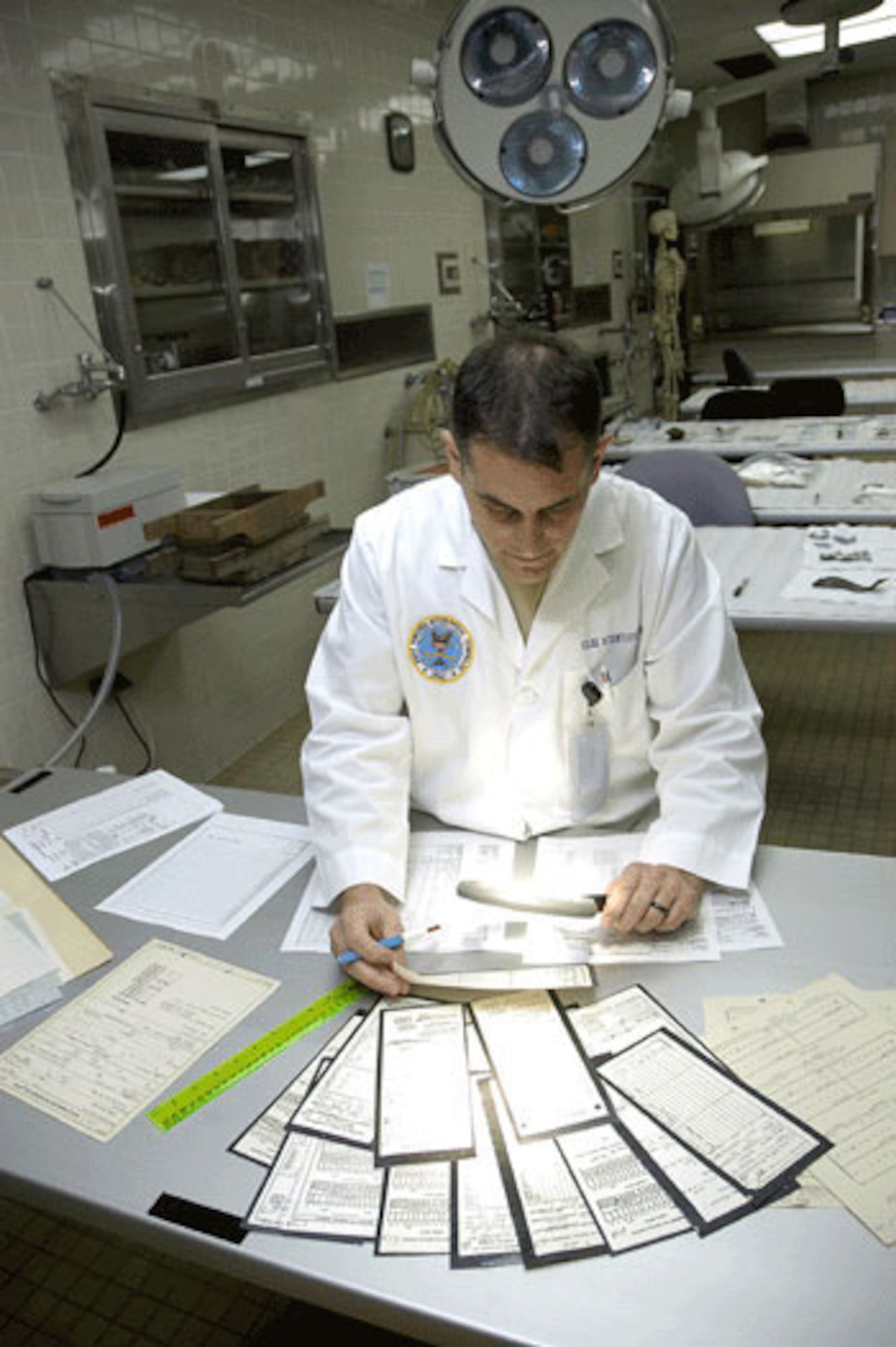HICKAM AIR FORCE BASE, Hawaii -- Odontologist Lt. Col. Gregory Silver, of the Joint POW/MIA Accounting Command's Central Identification Laboratory, scrubs dental records of unaccounted-for soldiers from the Korean War. Confirming the accuracy of each record can take several hours since all military dental records were done by hand during the Korean War, and mistakes were commonplace due to human error.  (JPAC photo by U.S. Navy Photographer's Mate 2nd Class Elizabeth A. Edwards)