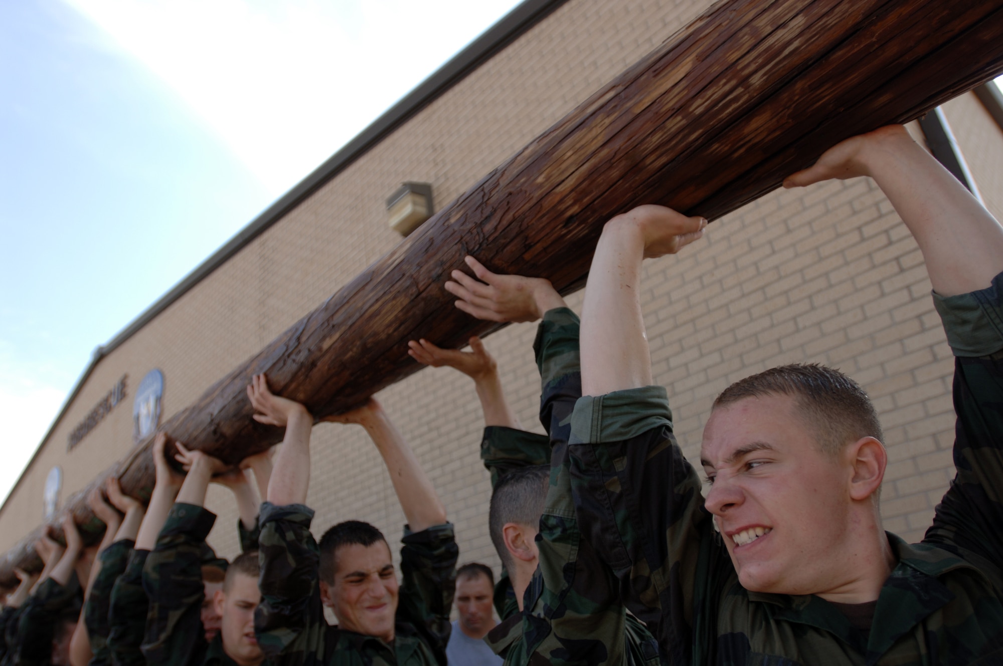 Instructors soak Airman 1st Class Michael Lauria and fellow trainees as they carry a log during pararescue indoctrination training at Lackland Air Force Base, Texas, on Thursday, April 6, 2006. The 10-week indoctrination training is the first hurdle of intense physical and mental training for pararescue hopefuls. It prepares them for the 12 to 15 months of extreme training they must pass to become Air Force pararescue members. (U.S. Air Force photo/Tech. Sgt Cecilio M. Ricardo Jr.) 