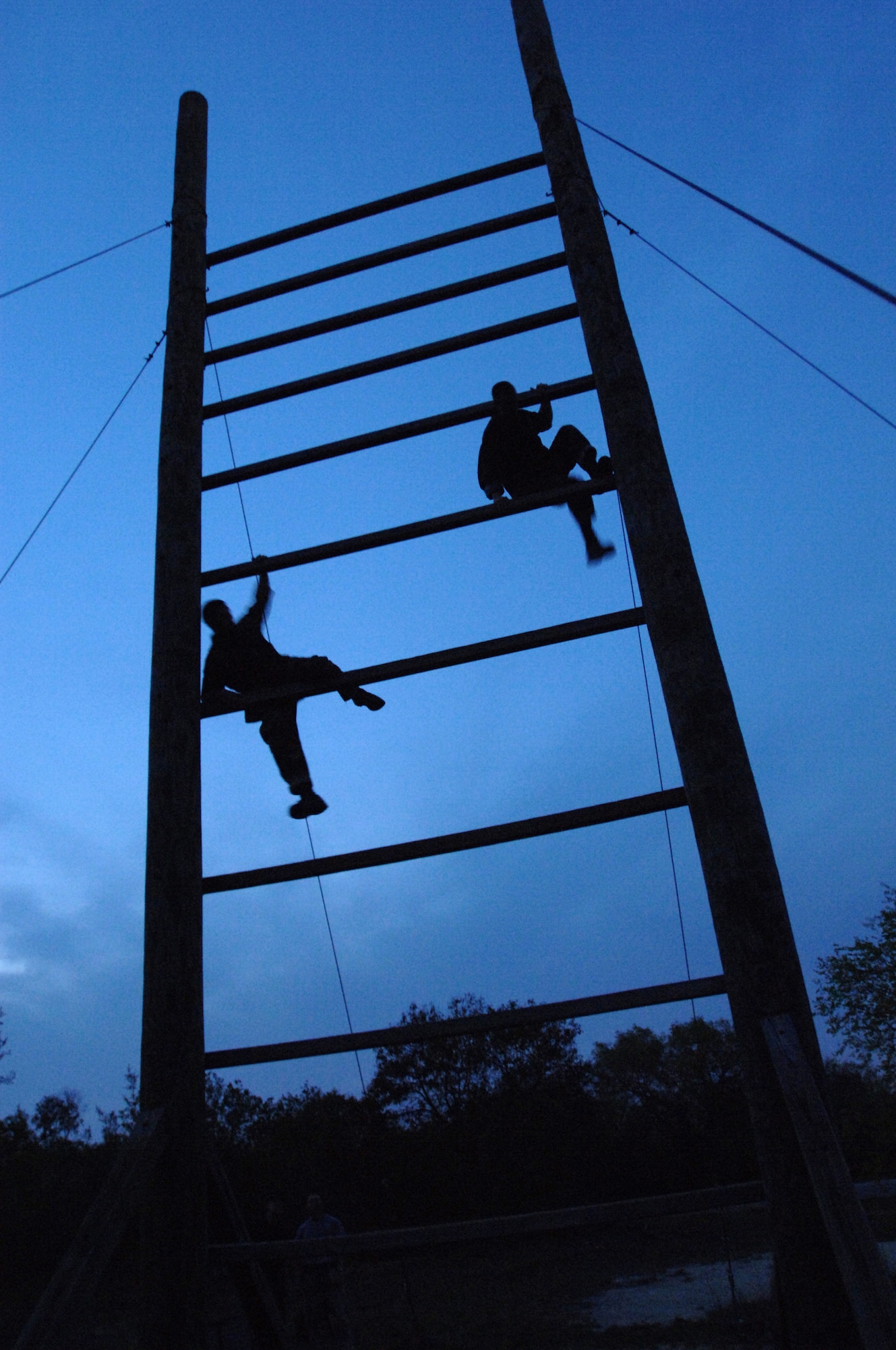 Two trainees run through an obstacle course during pararescue indoctrination training at Lackland Air Force Base, Texas, on Thursday, April 6, 2006. The 10-week indoctrination training is the first hurdle of intense physical and mental training for pararescue hopefuls. It prepares them for the 12 to 15 months of extreme training they must pass to become Air Force pararescue members. (U.S. Air Force photo/Tech. Sgt Cecilio M. Ricardo Jr.) 
