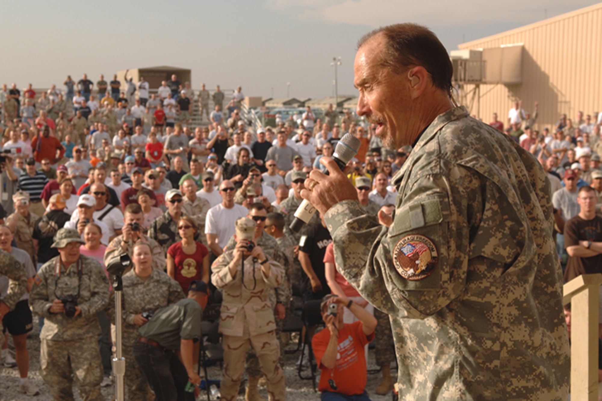 Lee Greenwood entertains the crowd during the Patriotic World Tour's third performance stop in Southwest Asia. The tour is sponsored by Air Force Reserve Command. (U.S. Air Force photo/Ken Hackman)

