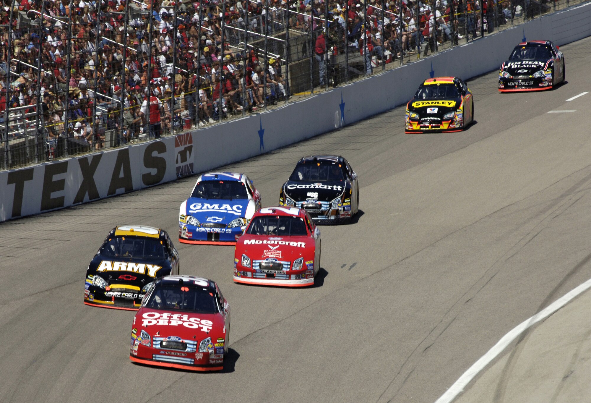 The number 21 Motorcraft/Air Force NASCAR driven by Ken Schrader, encounters traffic through turn four at the NASCAR Nextel Cup, Samsung/RadioShack 500 on Sunday, April 9, 2006, at Texas Motor Speedway. Schrader finished 16th after qualifying 32nd in a field of 43 drivers. (U.S. Air Force photo/Senior Airman Brian Ferguson)