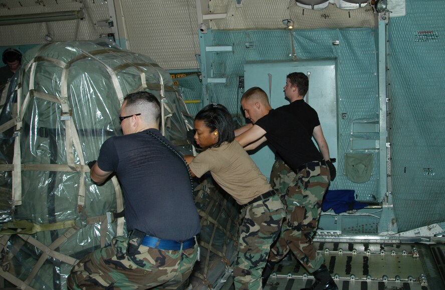 60th Aerial Port Squadron members Airman 1st Class Eric Tolon, Senior Airman Susan P. Henry, Airman 1st Class Josiah Viklund and Airman 1st Class Christopher Coehlo load disaster relief supplies onto a C-5 aircraft headed for Biloxi, Miss. Travis Air Force Base, Calif. began relief efforts this week as a result of the Hurricane Katrina disaster. (US Air Force photoby T.C. Tolliver)