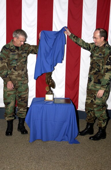 Brig. Gen. P. David Gillett Jr., Director of Maintenance, Deputy Chief of Staff for Installations and Logistics, Headquarters U.S. Air Force, Washington, D.C. and 349th Air Mobility Wing Commander Brig. Ge. Thomas M. Gisler, Jr. unveil the Daedalian Trophy at Travis Air Force Base, Calif. which was awarded to the 60th and 349th Maintenance Groups for winning Best Maintenance Groups in the USAF for 2004. (US Air Force photoby Arielle Kohn)