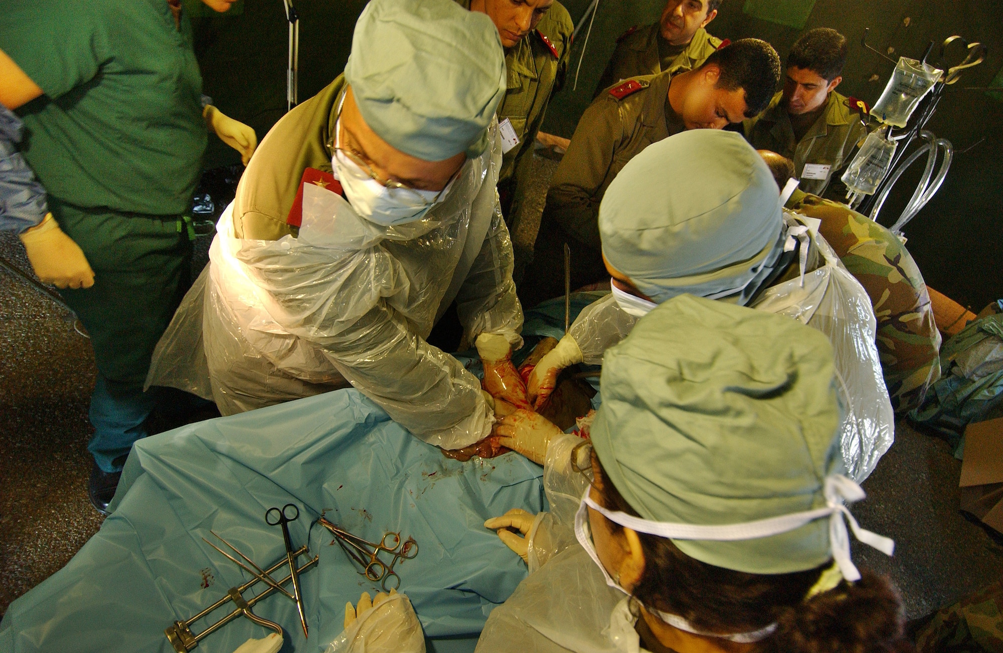 Tunisian military physicians work in field conditions during the mass casualty exercise portion for Exercise MEDLite 2006 at Kharrouba Air Base in Bizerte, Tunisia, Monday, April 3, 2006. MEDLite 2006 provides the opportunity for Air Force medical specialists to exchange medical skills, techniques and procedures with Tunisian military medical personnel. (U.S. Air Force photo/Tech. Sgt. Rick Sforza)