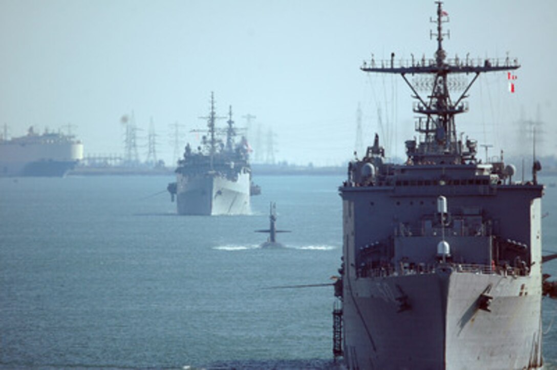 The USS Carter Hall (LSD 50), USS Norfolk (SSN 714), and amphibious transport dock ship USS Austin (LPD 4) steam in file as they transit through the Suez Canal on April 7, 2006. The ships of Expeditionary Strike Group Eight are on their way to the Mediterranean Sea after a deployment in the 5th Fleet area of operations. 