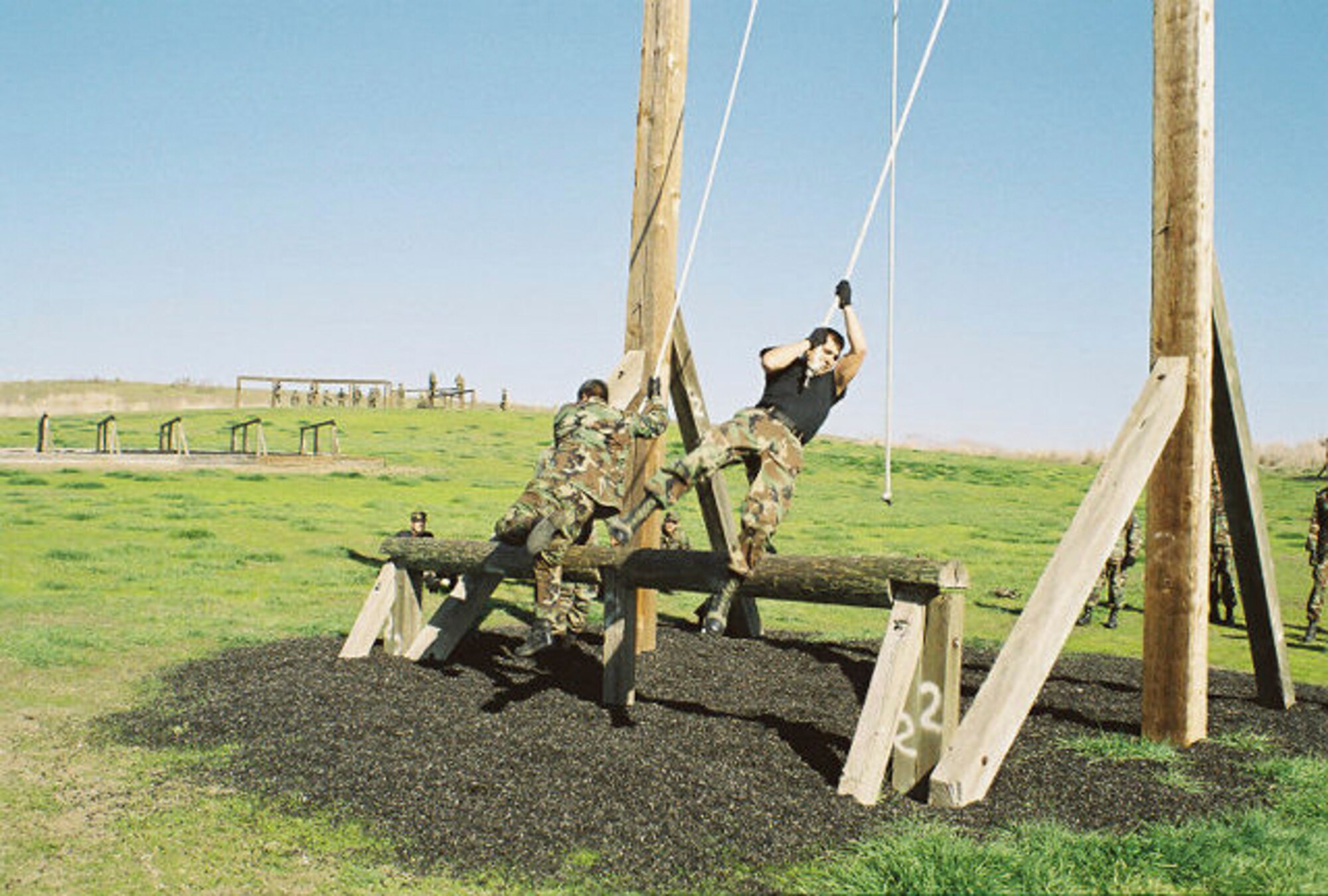 Members of the 570th Global Mobility Squadron complete an Army obstacle training course in Dublin, Calif.  The wing participates in many exercises throughout the year to maintain war readiness.             