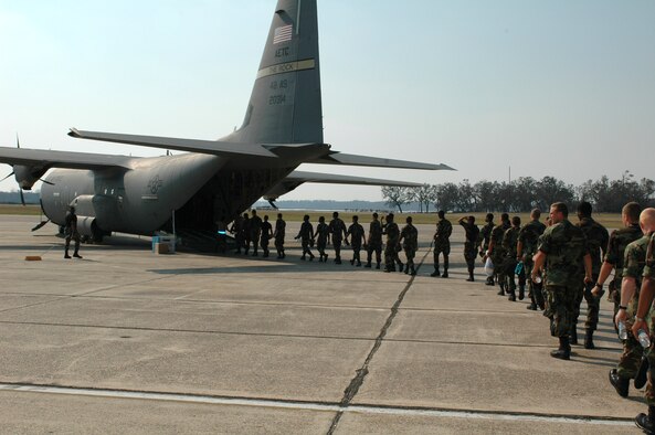 Members from the 615th Contingency Response Wing help load dispaced students from Keesler Air Force Base, Miss., onto a C-130.  Part of the wing was deployed in support of humanitarian relief for Americans affected by Hurricane Katrina.