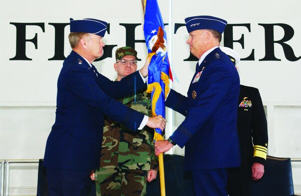 Lt. Gen. Gary North (right), 9th Air Force and U.S. Central Command Air Forces commander, takes the 9th Air Force guidon from Gen. Ronald Keys, Air Combat Command commander, Feb. 16 in Hangar 1614.
