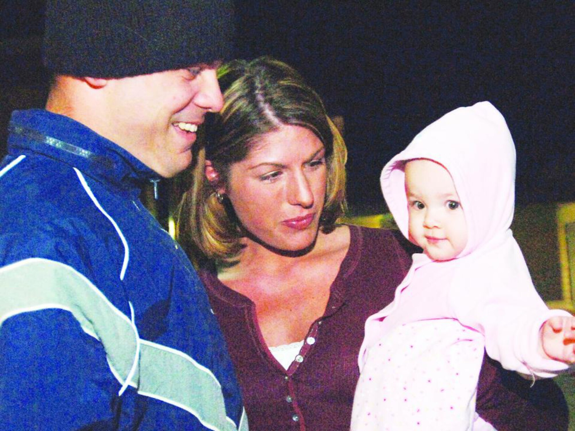 Staff Sgt. Michael Stevens, 20th Security Forces Squadron, is greeted Saturday by his wife, Staff Sgt. Anna Stevens, 20th Maintenance Operations Squadron, and their daughter, Morgan. Sgt. Stevens and 30 other 20th SFS members returned from a deployment to Balad and Ali Air Bases, Iraq. 