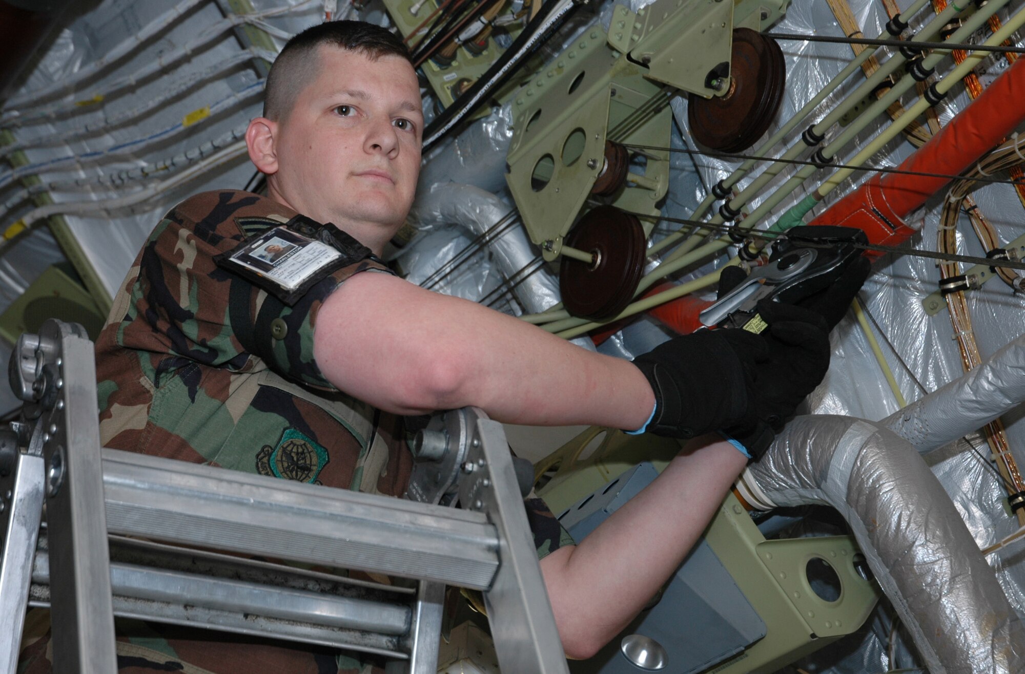 Senior Airman Jeremy Ward, 315th Maintenance Squadron, does a rudder cable tension check inside a C-17.  Airman Ward was the first reservist to win the Leadership Award and Distinguished Graduate Award from the Charleston Airman Leadership School. (Photo by Tech. Sgt. Mark Kleber, USAFR)