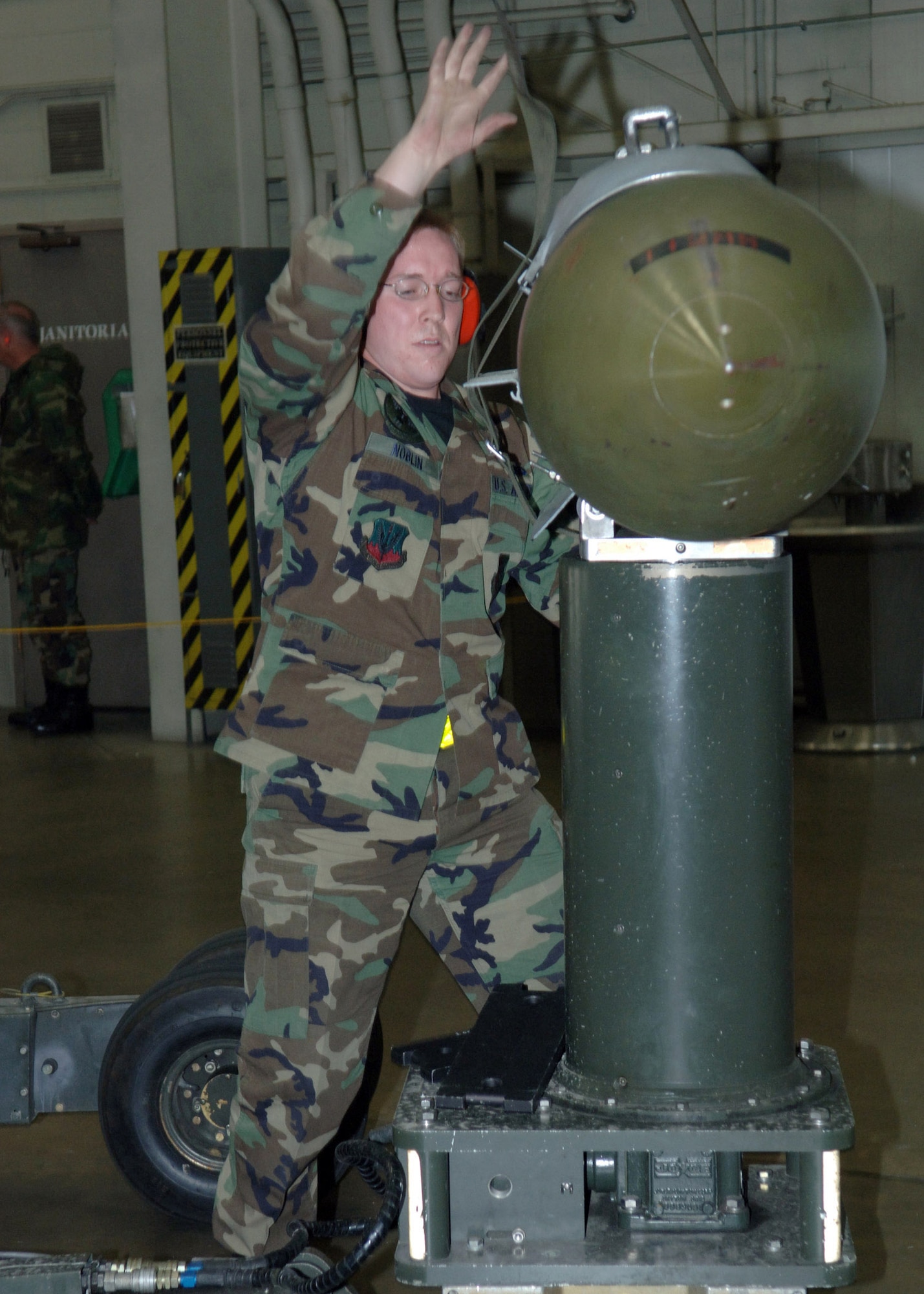 Senior Airman Eric Noblin loads a weapon during a crew competition at Ellsworth Air Force Base, S.D., on Friday, April 7, 2006. Each crew is rated on their time and efficiency when loading bombs onto the armament systems trainer. Airman Noblin is an aircraft armament systems specialist with the 34th Aircraft Maintenance Unit. (U.S. Air Force photo/Airman Angela Ruiz) 