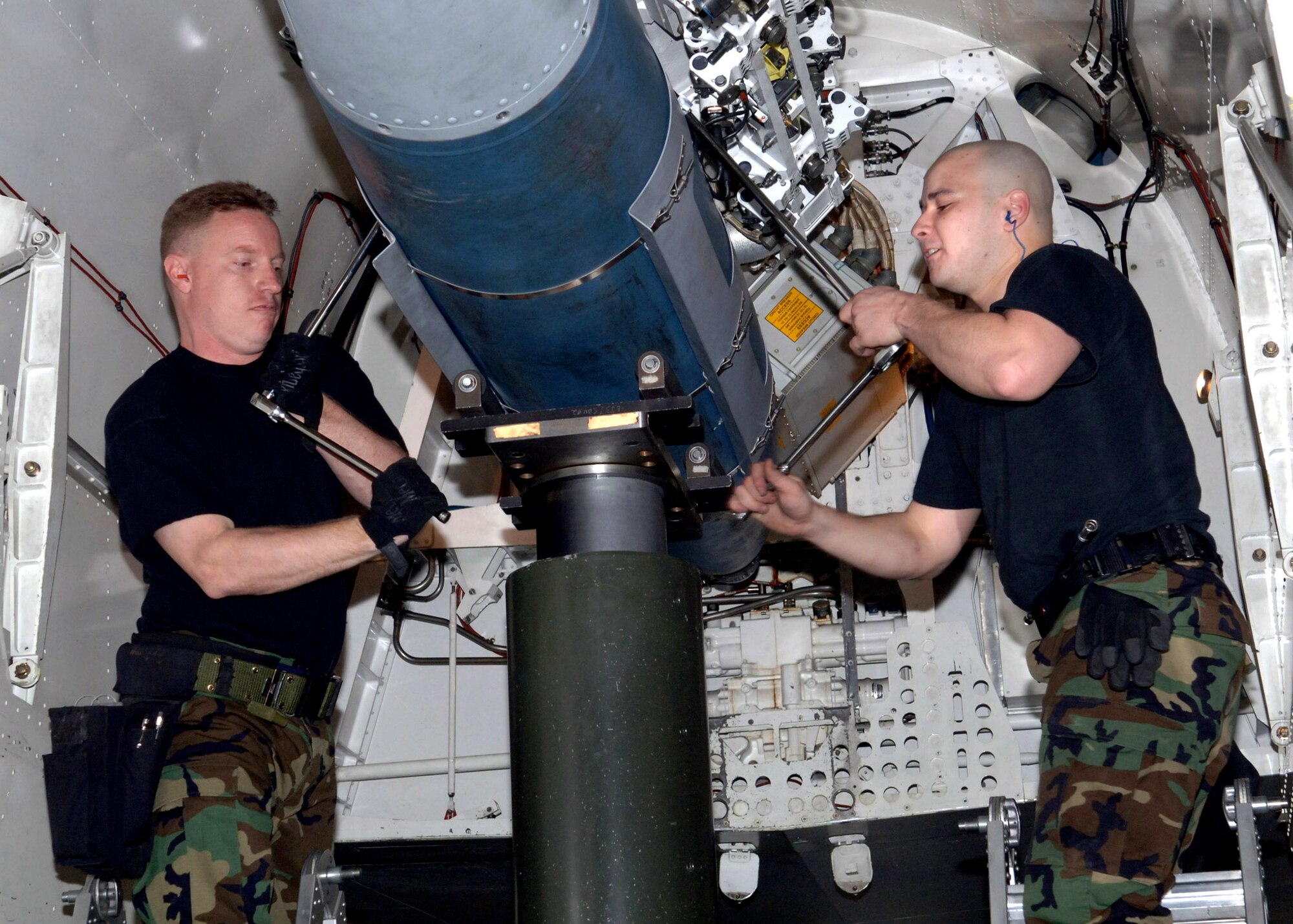Staff Sgt. Jason Murphy and Senior Airman Andrew Littleton load weapons during a crew competition at Ellsworth Air Force Base, S.D., on Friday, April 7, 2006. Each crew is rated on their time and efficiency when loading bombs onto the armament systems trainer. Both are aircraft armament systems specialists with the 34th Aircraft Maintenance Unit. (U.S. Air Force photo/Airman Angela Ruiz) 