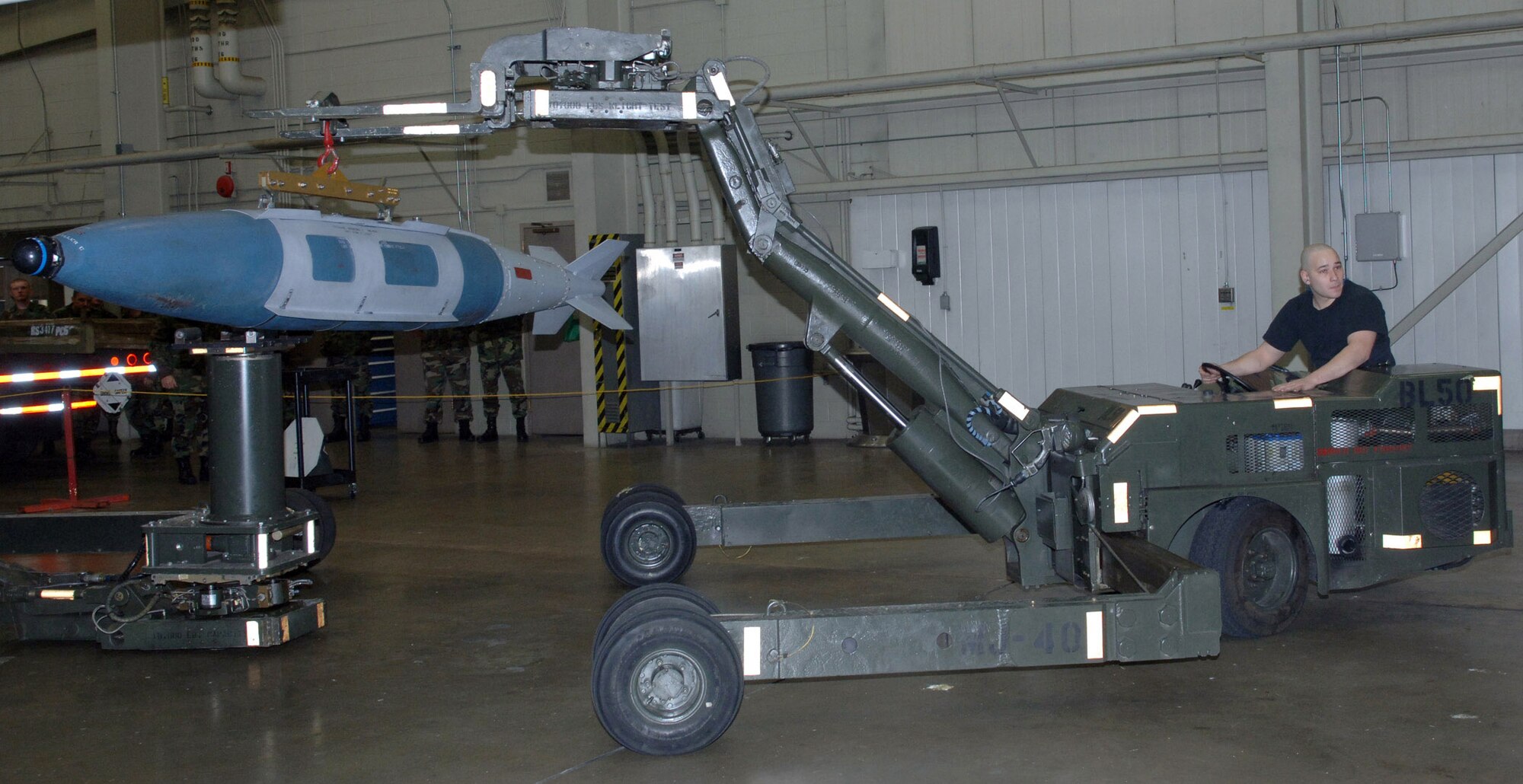 Senior Airman Andrew Littleton loads weapons during a crew competition at Ellsworth Air Force Base, S.D., on Friday, April 7, 2006. Each crew is rated on their time and efficiency when loading bombs onto the armament systems trainer. Airman Littleton is an aircraft armament systems specialist with the 34th Aircraft Maintenance Unit. (U.S. Air Force photo/Airman Angela Ruiz) 