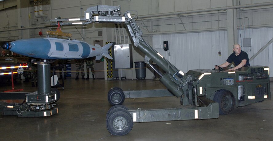 Senior Airman Andrew Littleton loads weapons during a crew competition at Ellsworth Air Force Base, S.D., on Friday, April 7, 2006. Each crew is rated on their time and efficiency when loading bombs onto the armament systems trainer. Airman Littleton is an aircraft armament systems specialist with the 34th Aircraft Maintenance Unit. (U.S. Air Force photo/Airman Angela Ruiz) 