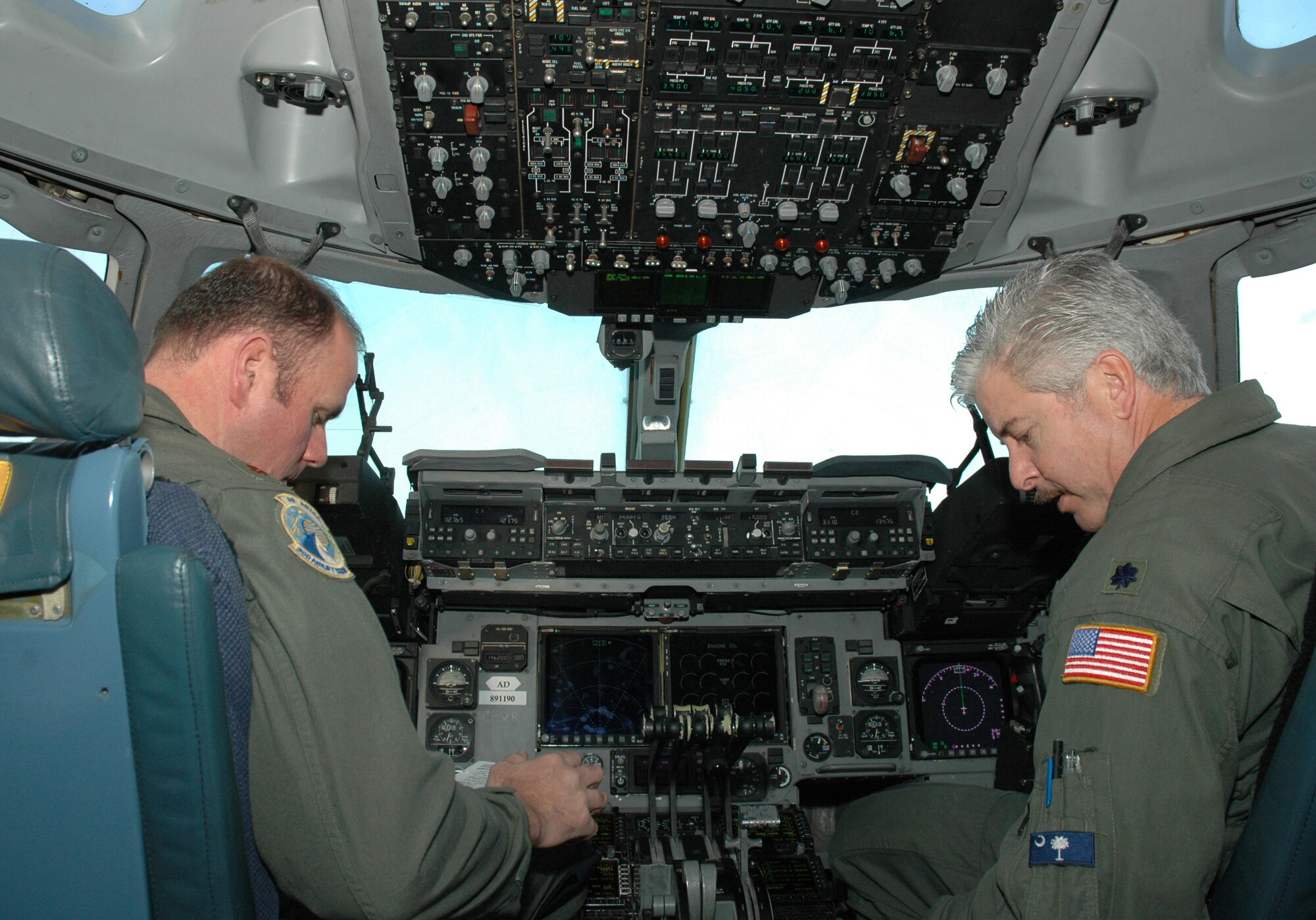 Maj. Lance Livesey (left) and Lt. Col. Bert Bailey, reservists assigned to the 300th Airlift Squadron, Charleston AFB, S.C., fly a vital training mission aboard a C-17 Globemaster III to St. Lucia. (Photo by 1st Lt. Wayne Capps, USAFR)