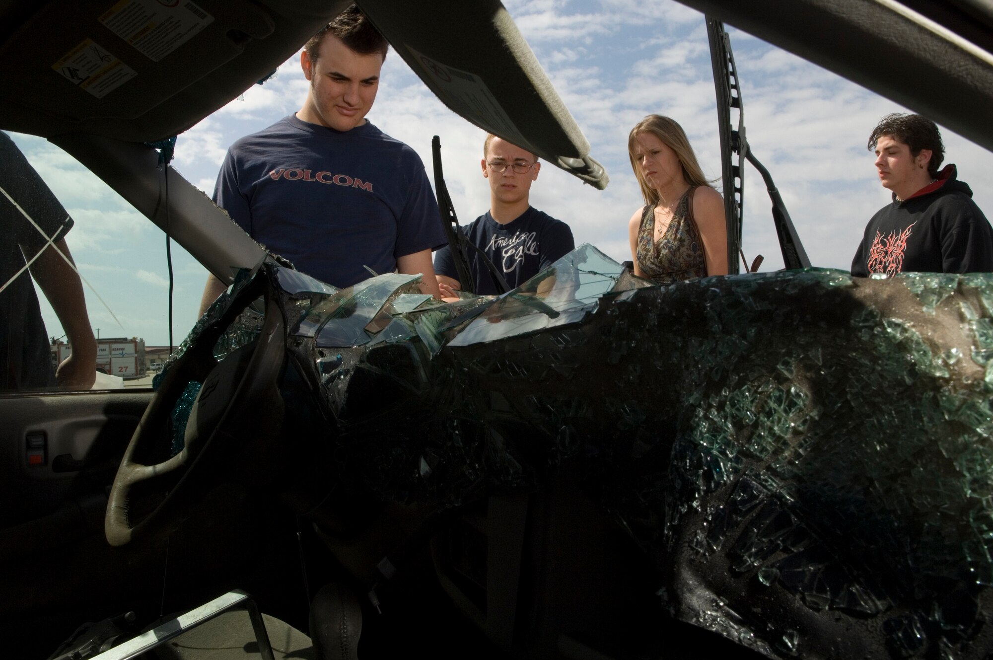 Students from Eau Gallie High School in Melbourne, Fla., look over a wrecked car Tuesday, April 11, 2006, during Operation NOW events at Patrick Air Force Base, Fla. NOW -- which stands for Not on Our Watch -- is designed to scare teens into safer driving habits. Approximately 800 high school seniors attended the first day of the three-day event. (U.S. Air Force photo/Master Sgt. Jack Braden)