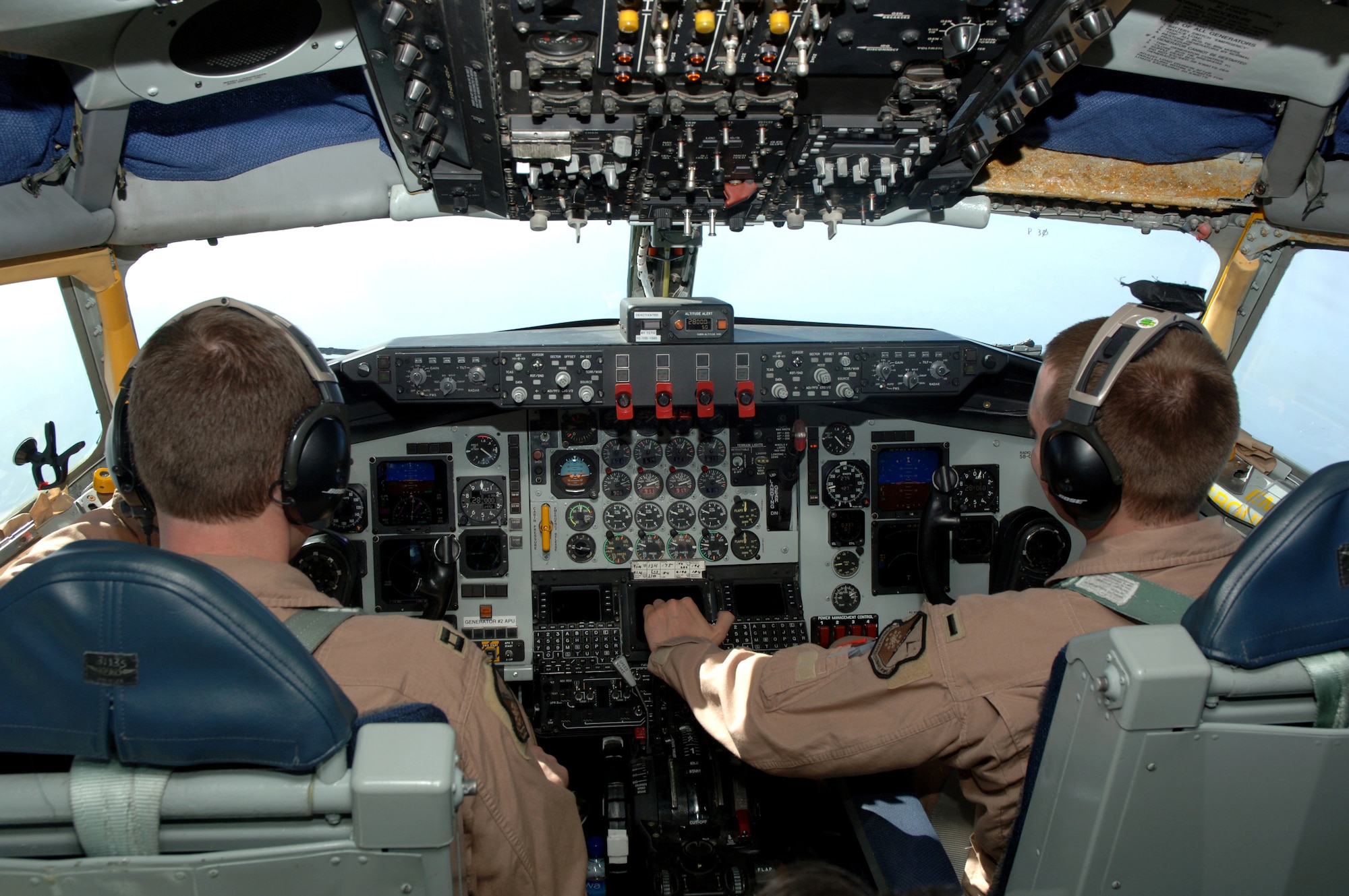 Capt. Brian Temple (left) and 1st Lt. Chris Reid of the 340th Expeditionary Air Refueling Squadron fly their KC-135 Stratotanker during an aerial refueling mission over Southwest Asia on Tuesday, April 11, 2006. (U.S. Air Force photo/Staff Sgt. Joshua Strang) 
