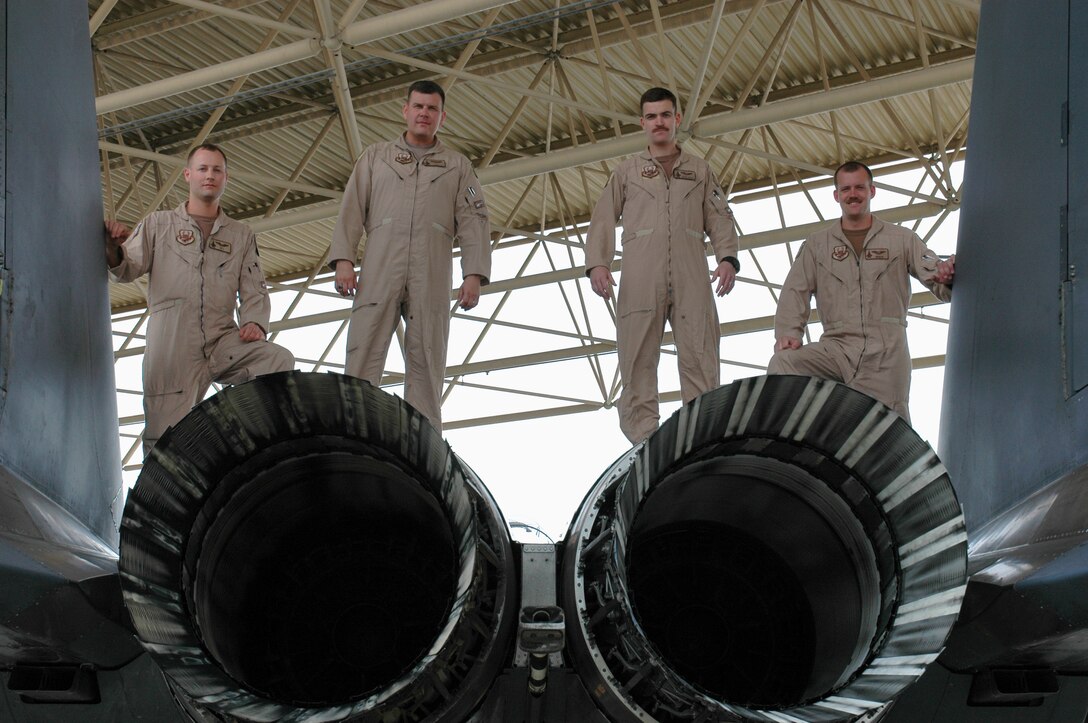 From left to right, Bigus, Voodoo, JJ and Dez, F-15E Strike Eagle pilots from the 336th Expeditionary Fighter Squadron, recently helped save the lives of nearly 20 soldiers during a recent sortie in Southwest Asia. F-15s often provide support to ground forces as well as nontraditional intelligence, surveillance and reconnaissance. Call signs were used in place of the pilots' names for security. (U.S. Air Force photo by Maj. Ann Peru Knabe)
