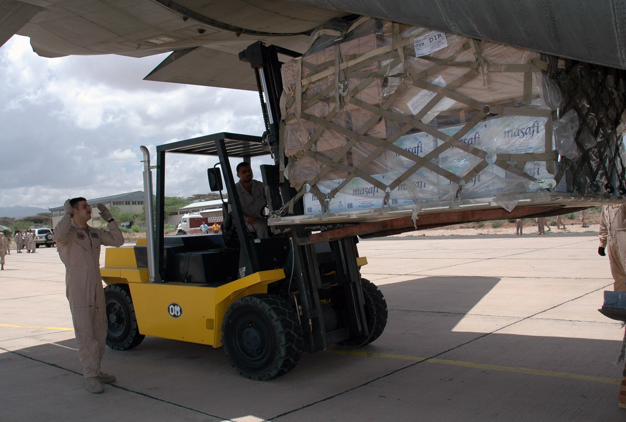 Master Sgt. Ramon Feliciano, 746th Expeditionary Airlift Squadron loadmaster, removes luggage from a C-130 Hercules in preparation to load supplies bound for Ethiopia March 24. (U.S. Air Force photos by Maj. Ann Knabe)