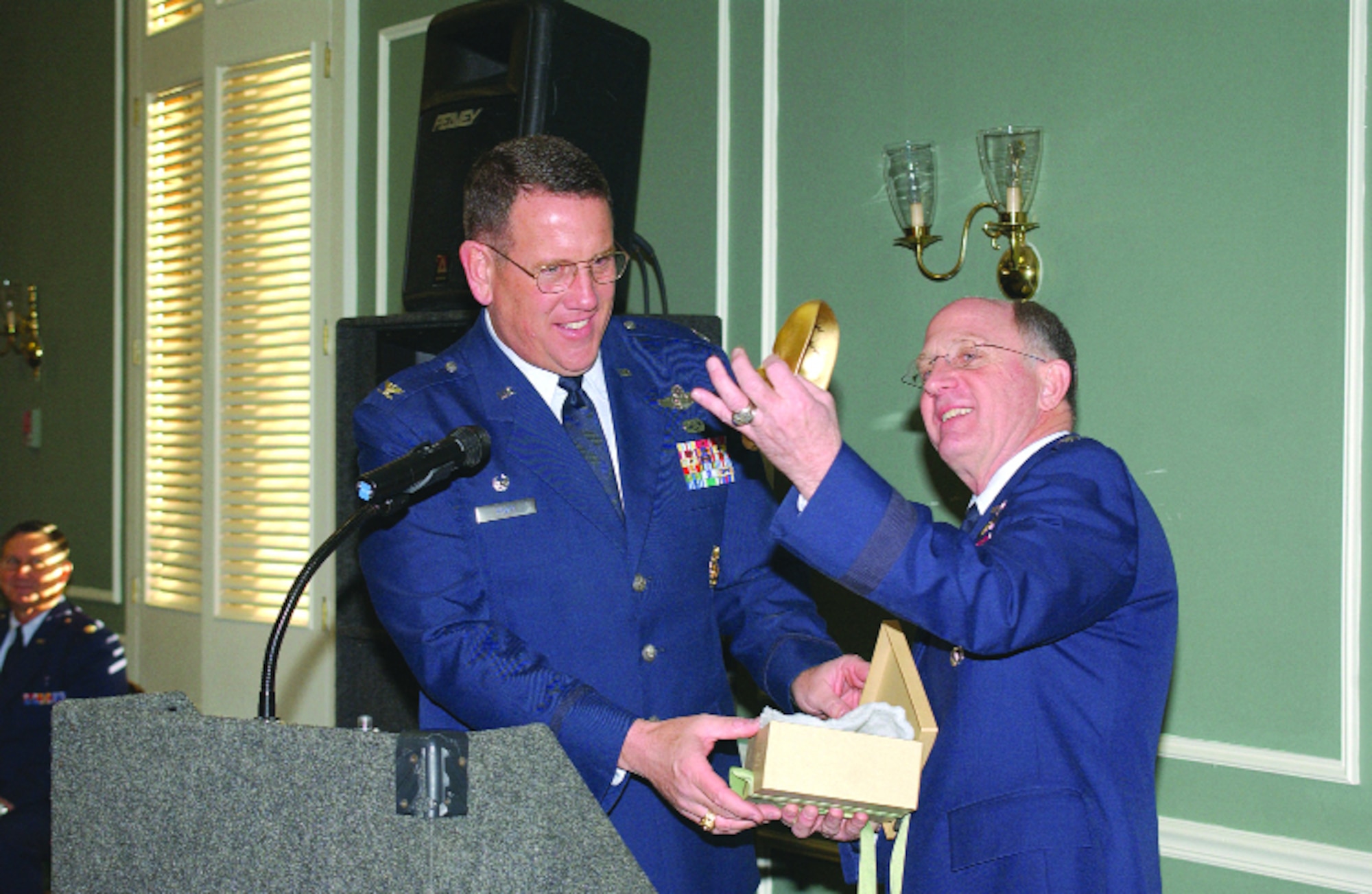 Col. Bill Hyatt (left), 20th Fighter Wing commander, presents Chaplain (Maj. Gen.) Charles C. Baldwin, Air Force Chaplains Service chief, a gift Jan. 20 after the chaplain's speech at the National Prayer Breakfast in the Carolina Skies banquet room.