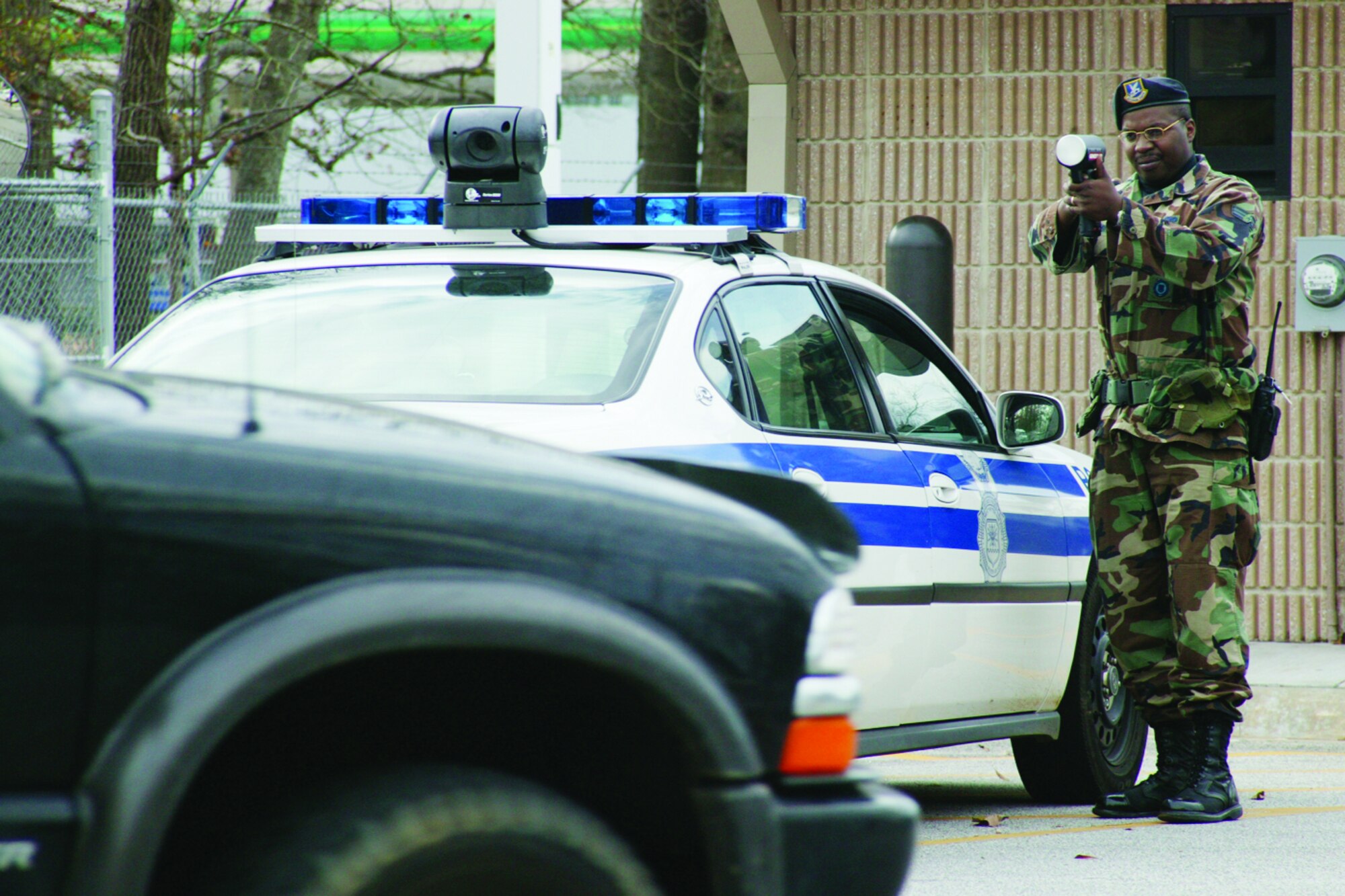 Senior Airman Daryl Harper, 20th Security Forces Squadron, uses a radar gun to check the speed of passing motorists.  
