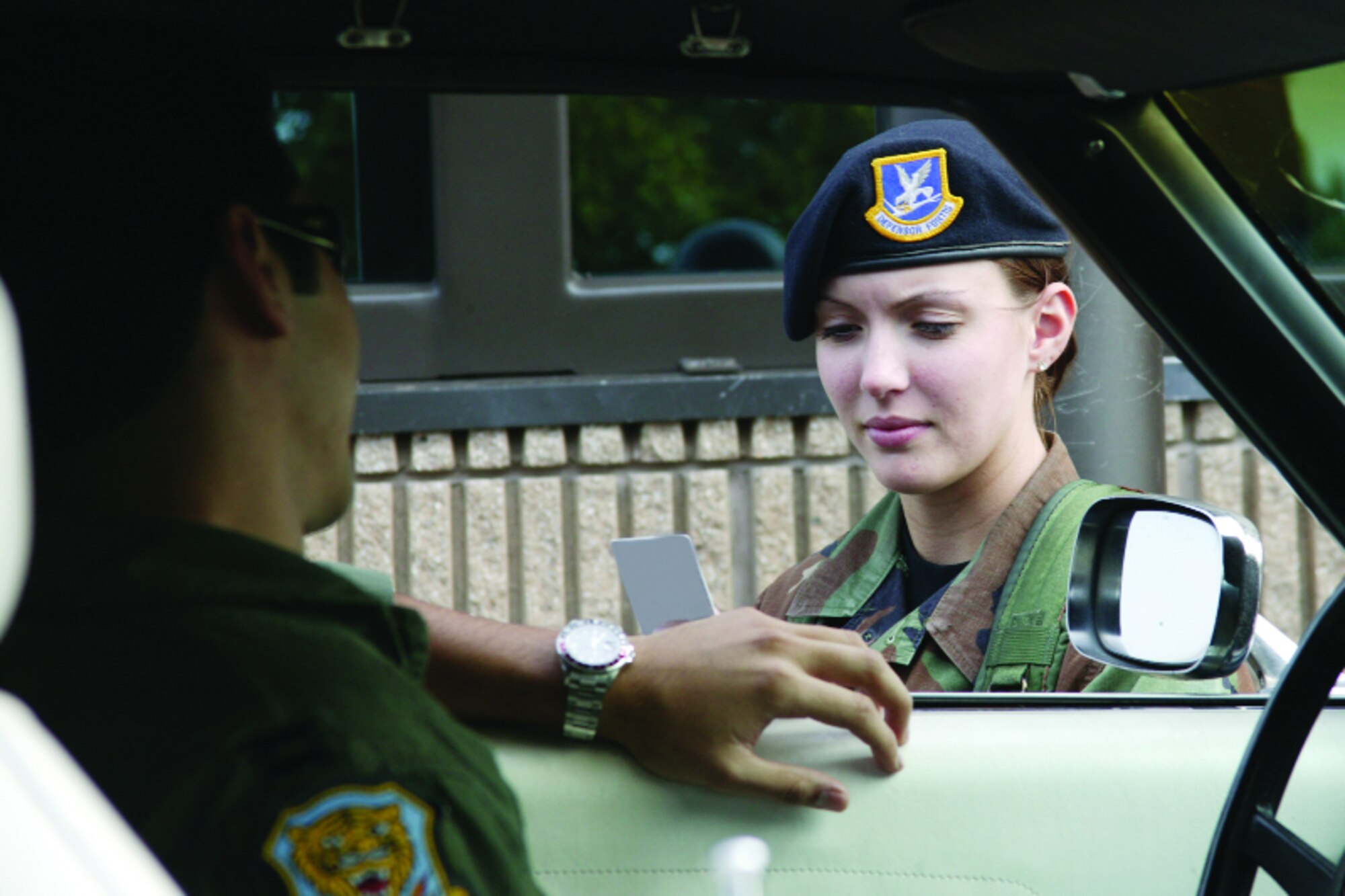 Airman 1st Class Crystal Moore, 20th SFS, checks an ID card at a gate. 