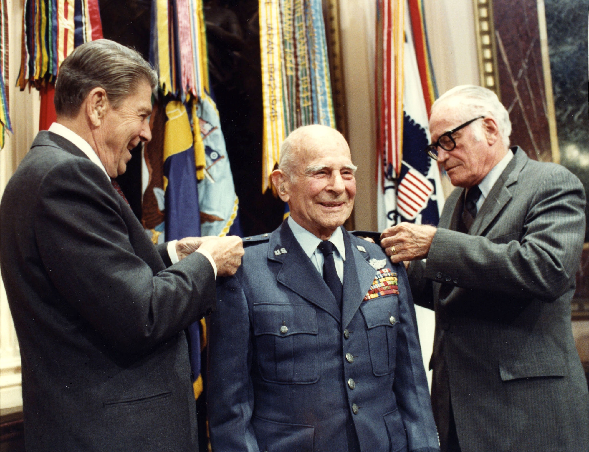 President Ronald Reagan and Senator Barry L. Goldwater pin the fourth star on Gen. James Doolittle April 10, 1985, 26 years after his retirement from the U.S. Air Force. General Doolittle was advanced to four-star rank by Senate confirmation, making him the first person in Air Force Reserve history to wear four stars.  (White House photo by Bill Fitz-Patrick)