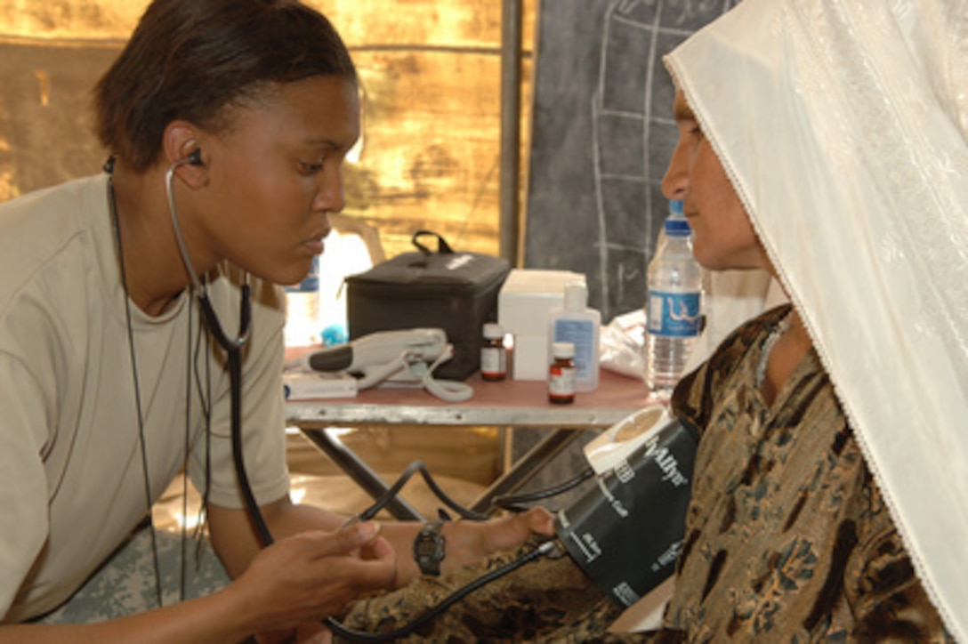 U.S. Army Pfc. Jaimie Jones reads the blood pressure of a local woman during a medical civic assistance program in the village of Stin in the Balkh province of Afghanistan on April 4, 2006. Jones is a 7th Special Forces Group medic. The medical civic assistance program was organized by Combined Joint Special Operation Task Force Afghanistan to bring medical care to people in remote areas. 