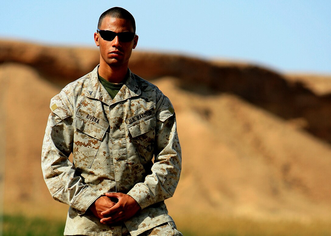Lance Cpl. Mike A. Rivera poses for a photo April 13 outside of his workspace in Al Asad, Iraq. Rivera is a future operation clerk with Marine Wing Headquarters Squadron 3, 3rd Marine Aircraft Wing and he will be deployed to here for one year in support of Operation Iraqi Freedom.
