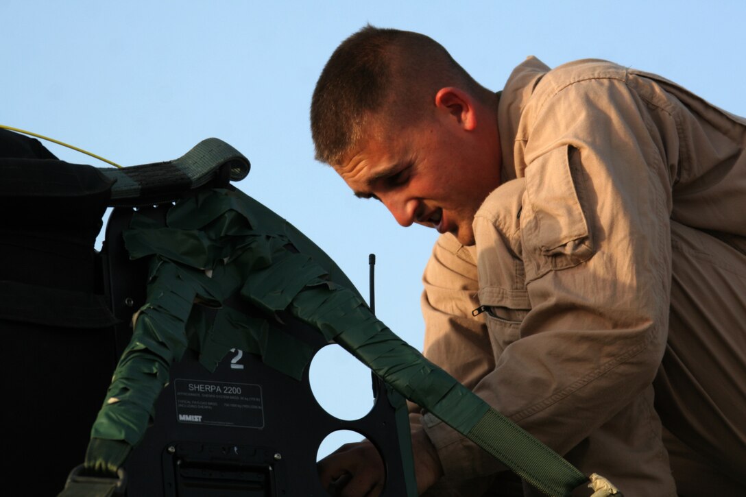 Cpl. Christopher M. Bird programs a Sherpa 1200 series parachute system at Al Asad, Iraq, April 13. Bird is an air delivery specialist with 1st Air Delivery Platoon, Combat Logistics Company 117, Combat Logistics Battalion 7, Combat Logistics Regiment 1, 1st Marine Logistics Group. He is a native of Jonesboro, Ark.