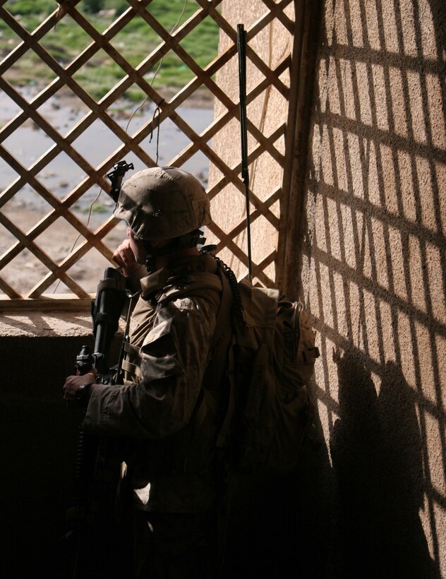 On 15 April 2006: U.S. Marine PFC Ernest Brady III, Mortarman, with 3rd Platoon, C Company, 1st Battalion, 1st Marine Regiment, Regimental Combat Team - 5, 1st Marine Division, I Marine Expeditionary Force, provides security during a security patrol through the Kandari Market in the vicinity of Forward Operating Base Abu Gharib. Regimental Combat Team Five is deployed with I MEF (FWD) in support of Operation Iraqi Freedom in the Al Anbar Province if Iraq (MNF-W) to develop the Iraqi Security Forces, facilitate the development of official rule of law through democratic government reforms, and continue the development of a market based economy centered on Iraqi Reconstruction. ::n::::n::(Official Marine Corps photo by Lance Corporal James J. Vooris, 1st Marine Division Combat Camera)::n::060415-M-8205V-004  (RELEASED)