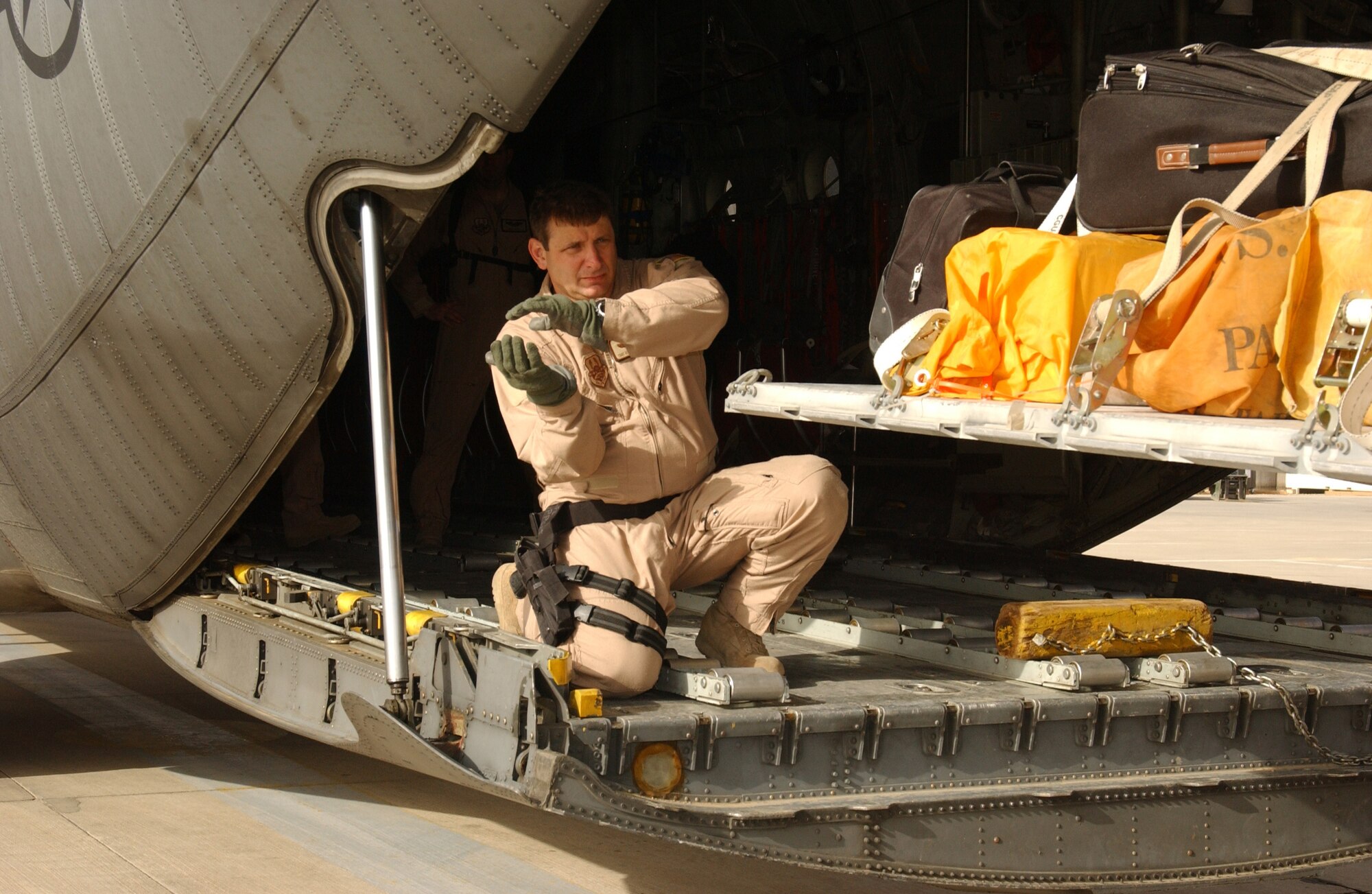 Loadmaster Tech. Sgt. Joe Van Benthuysen helps guide a pallet onto the ramp of a C-130 Hercules. He is with the 777th Expeditionary Airlift Squadron. (U.S. Air Force photo/Airman 1st Class Jason Ridder) 