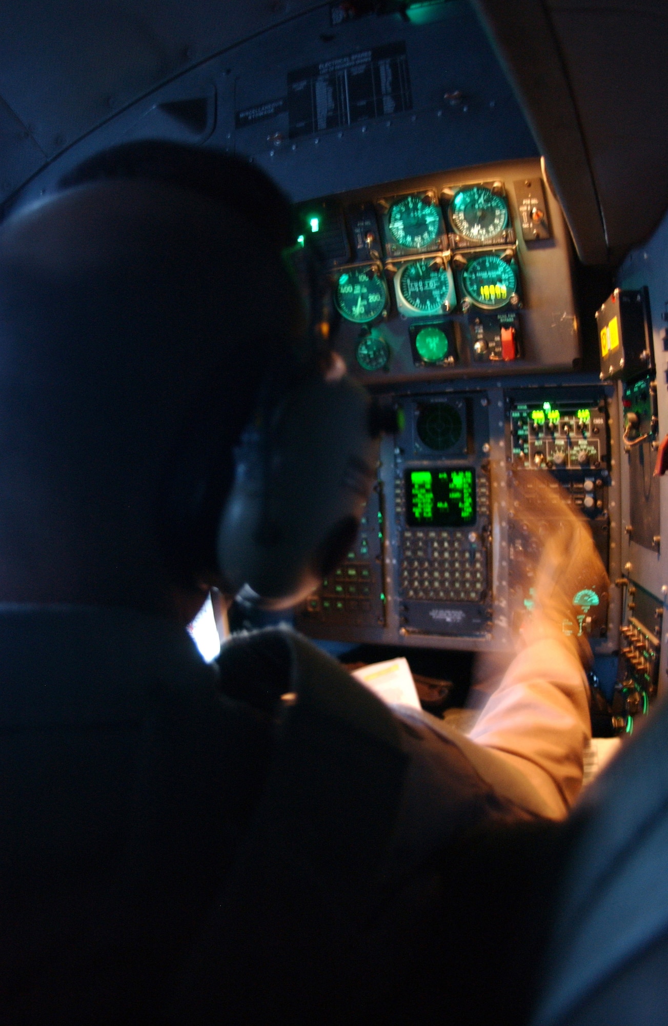 Navigator 1st Lt. Trent Smith adjusts coordinates during a flight out of Balad Air Base, Iraq. The average C-130 Hercules sortie keeps three trucks' worth of cargo off the road. That means in one average day, the transport?s six-Airman crew keeps 27 trucks -- and all of their support vehicles, drivers and security troops -- off Iraq?s roads. The lieutenant is with the 777th Expeditionary Airlift Squadron. (U.S. Air Force photo/Airman 1st Class Jason Ridder)    