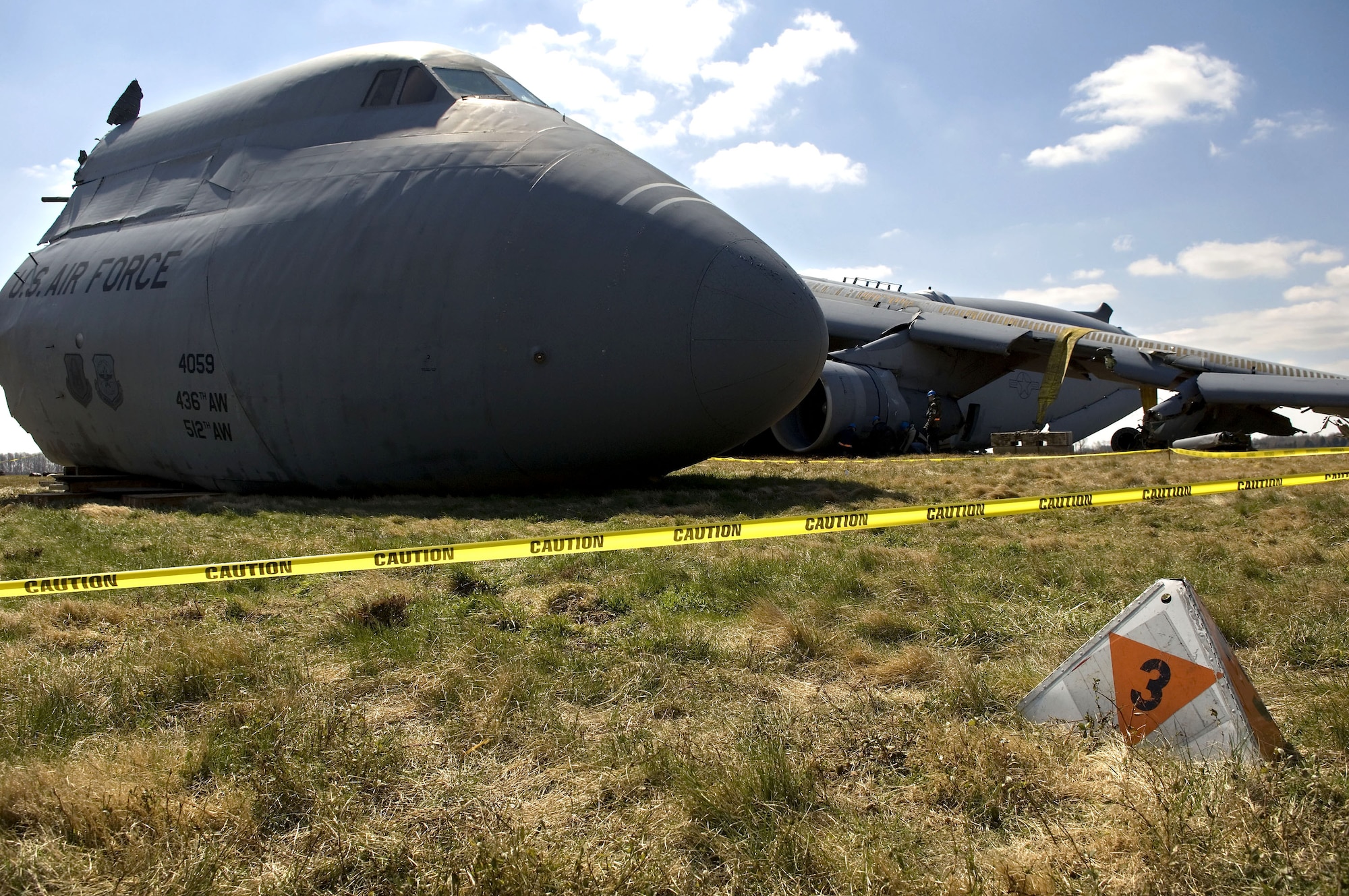 This C-5 Galaxy lies in a field on the south side of Dover Air Force Base, Del., after it crashed Monday, April 3, 2006.  Specialists roped off the area with caution tape to preserve the  scene until a safety investigation board completes its task.  (U.S. Air Force photo/Doug Curran 