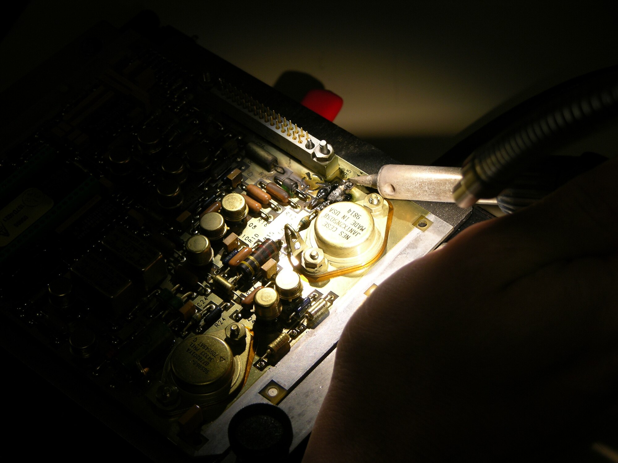 Staff Sgt. Matthew Turines fixes a broken circuit card in the shop.