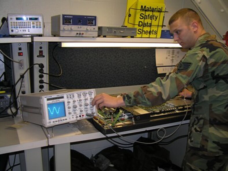 Staff Sgt. Matthew Turines works on a television in the shop.