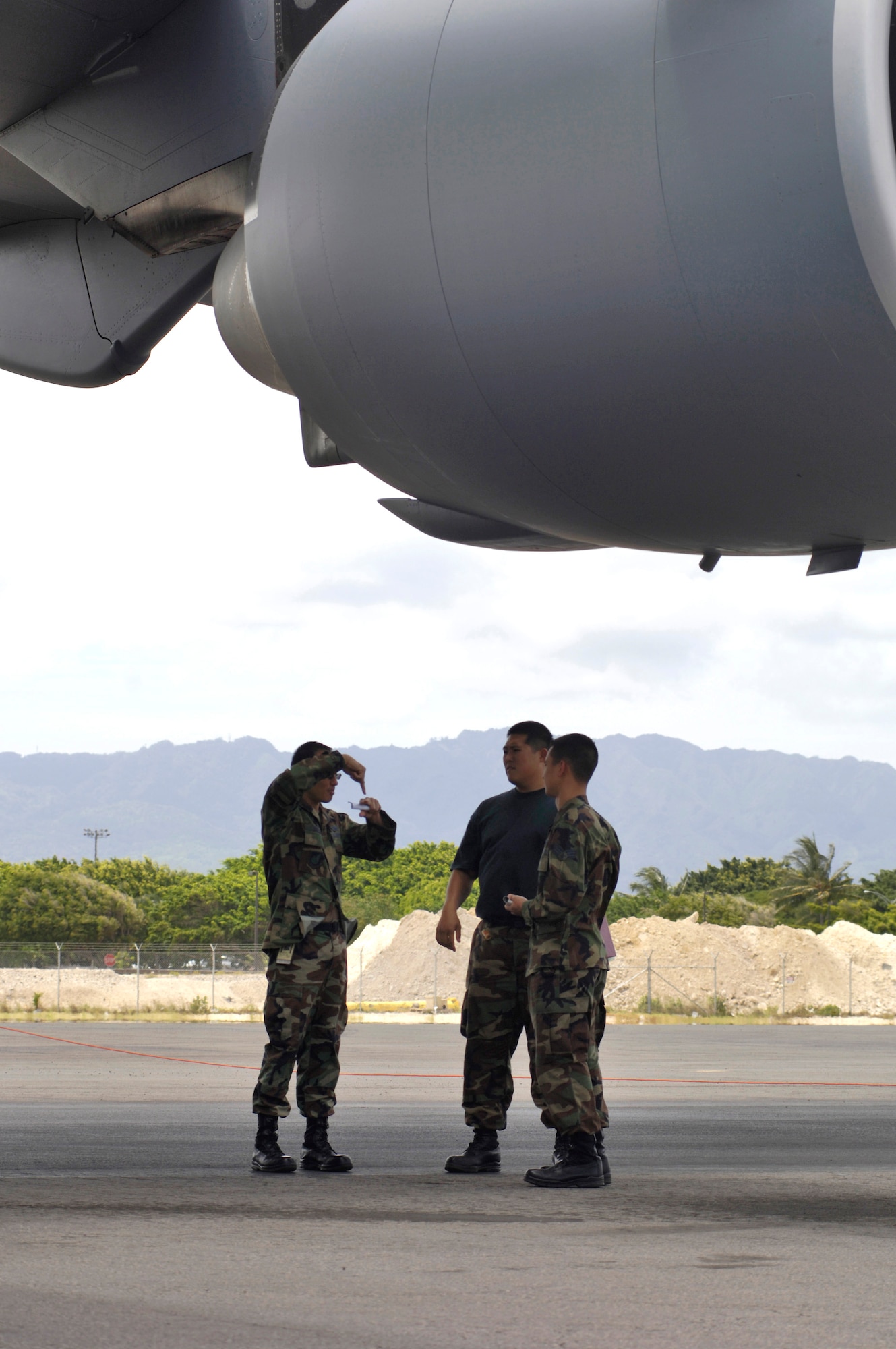 Airmen from the Hawaii Air National Guard's 154th Maintenance Squadron discuss maintenance procedures for a C-17 Globemaster III at Hickam Air Force Base, Hawaii, on Tuesday, April 11, 2006. Representatives from Boeing are helping the Air National Guard streamline their maintenance processes. (U.S. Air Force photo/Tech. Sgt. Shane A. Cuomo)