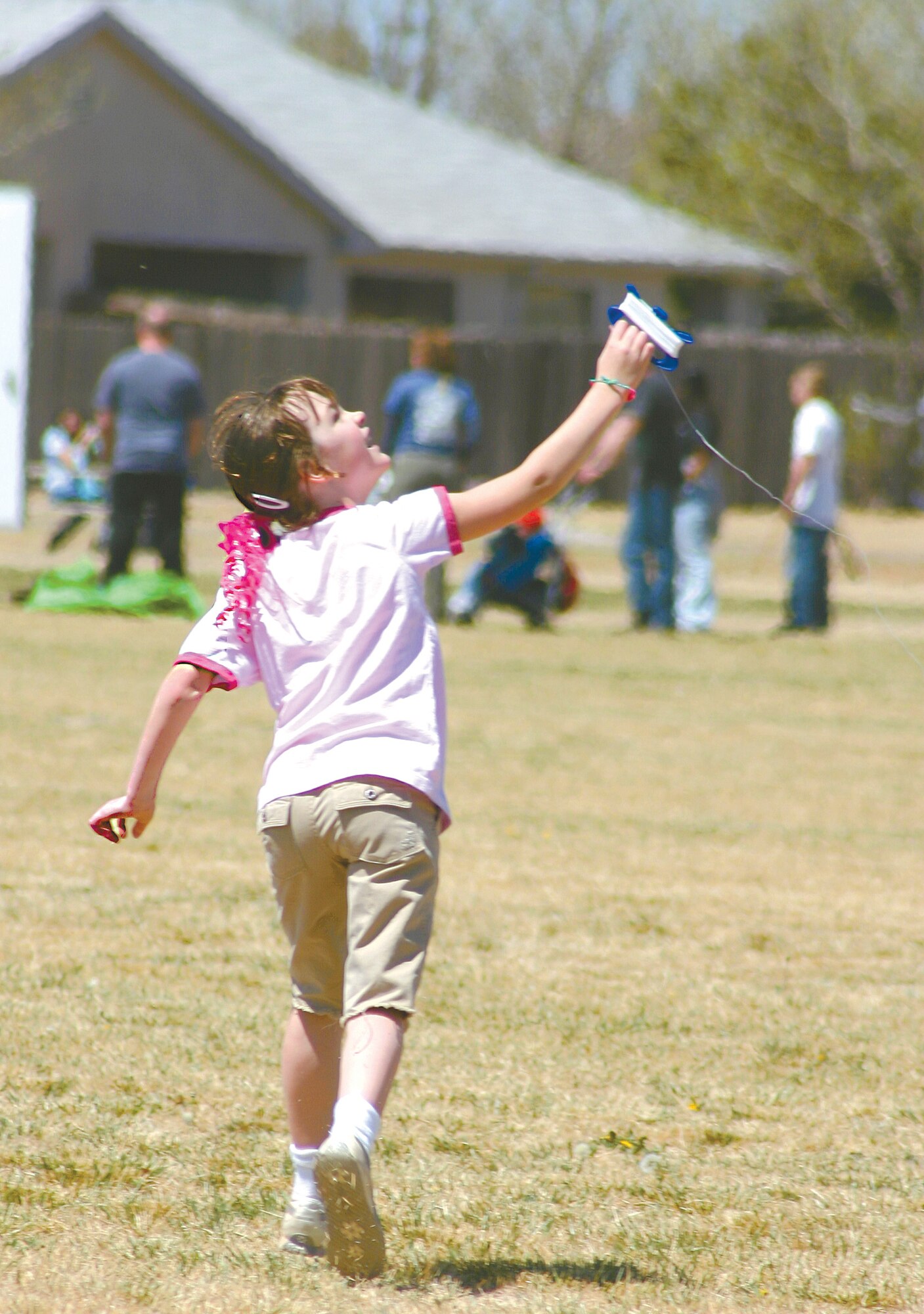 CANNON AIR FORCE BASE, N.M. -- Across the back row: Mychelle Simms, Mesa Elementary School teacher, Ronda Isabelle Winters, 9, took advantage of sparse breezes to fly her butterfly kites Saturday. Isabelle enjoyed the day with her mom, Vickie Winters, at the 3rd Annual Kite Karnival. (U.S. Air Force photo by Janet Taylor-Birkey)