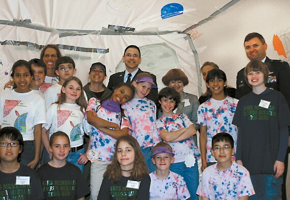 CANNON AIR FORCE BASE, N.M. -- Across the back row: Mychelle Simms, Mesa Elementary School teacher, Ronda Cole, Kirtland Air Force Bae, N.M., Lt. Col. James Lewis, 27th Mission Support Group deputy commander, Rhonda Seindenwurn, Clovis Municipal School superintendent, Jane West and Col. Scott West, 27th Fighter Wing commander, visit with a team from one of the habitats on display. (U.S. Air Force photo by Janet Taylor-Birkey)