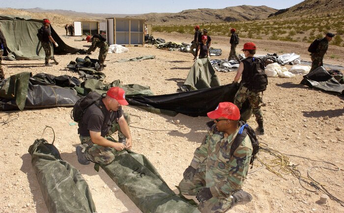 Airmen set up facilities during a bare-base build-up exercise at Nellis Air Force Base, Nev., April 8 to 9, 2006. The operation included beddown and construction operations for 120 Airmen.  The camp had a mobile field kitchen with generators, reverse osmosis water purification unit and field latrine equipment. The Airmen are with the 555th Red Horse Civil Engineer Squadron (U.S. Air Force photo/Master Sgt. Kevin J. Gruenwald)