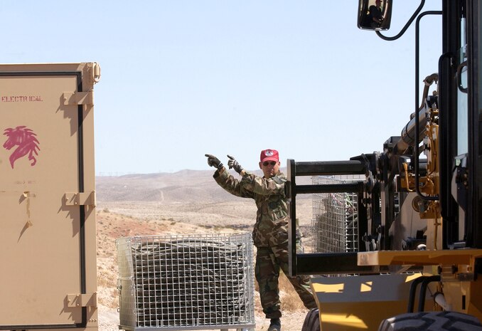 Staff Sgt. Jeff Ray marshals in electrical cable equipment during a bare-base build-up exercise at Nellis Air Force Base, Nev., April 8 to 9, 2006. The operation included beddown and construction operations for 120 Airmen. The camp had a mobile field kitchen with generators, reverse-osmosis water purification unit and field latrine equipment. Sergeant Ray is with the 555th Red Horse Civil Engineer Squadron. (U.S. Air Force photo/Master Sgt. Kevin J. Gruenwald)