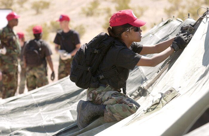 Tech. Sgt. Maryann Sawyer makes final adjustments to a tent during a bare-base build-up exercise at Nellis Air Force Base, Nev., April 8 to 9, 2006. The operation included beddown and construction operations for 120 Airmen. The camp had a mobile field kitchen with generators, reverse-osmosis water purification units and field latrine equipment. Sergeant Sawyer is with the 555th Red Horse Civil Engineer Squadron. (U.S. Air Force photo/Master Sgt. Kevin J. Gruenwald)