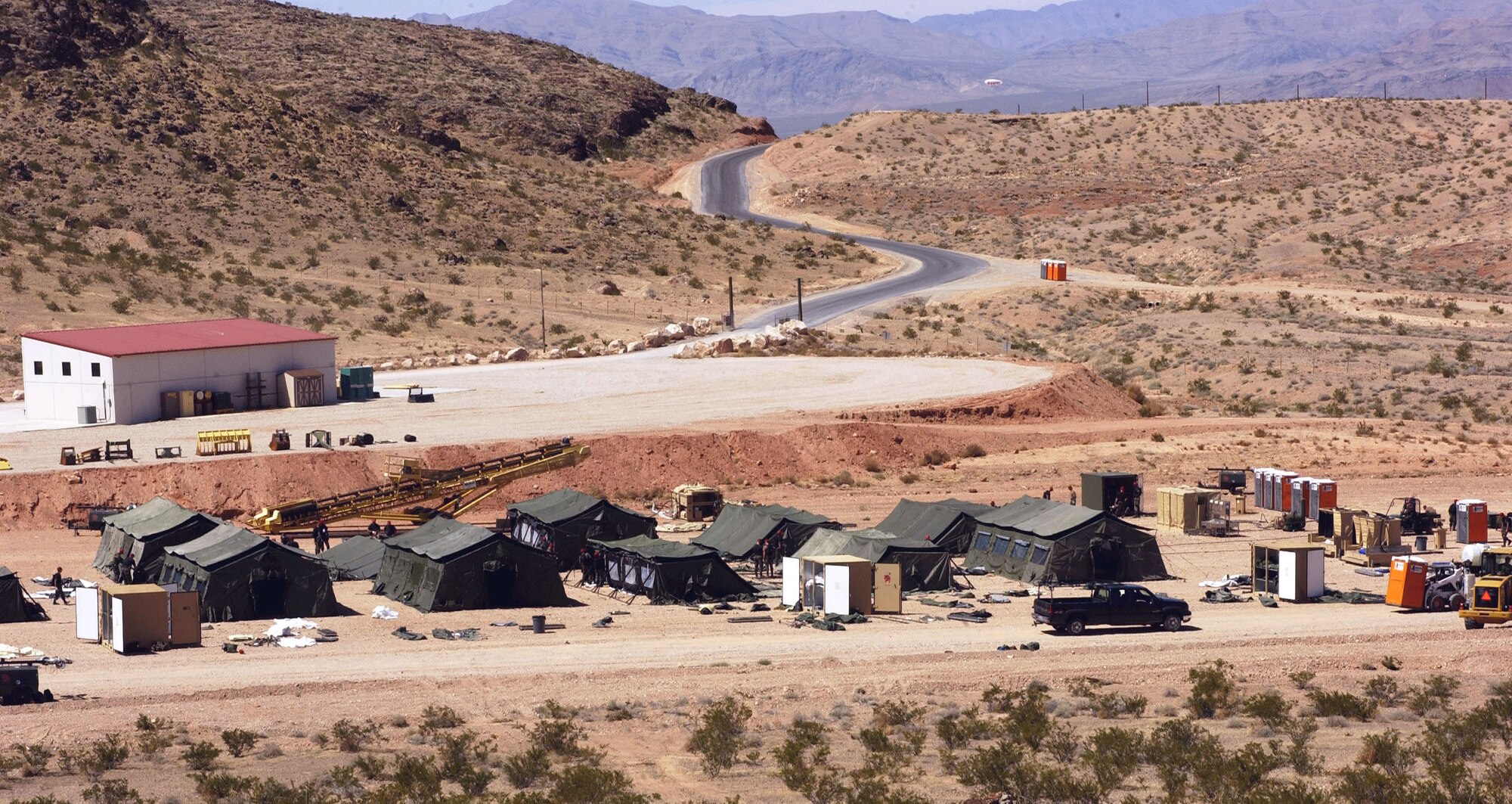 Airmen set up facilities during a bare-base build-up exercise at Nellis Air Force Base, Nev., April 8 to 9, 2006. The operation included beddown and construction operations for 120 Airmen. The camp had a mobile field kitchen with generators, reverse-osmosis water purification unit and field latrine equipment. The Airmen are with the 555th Red Horse Civil Engineer Squadron. (U.S. Air Force photo/Airman 1st Class Nadine Y. Barclay)